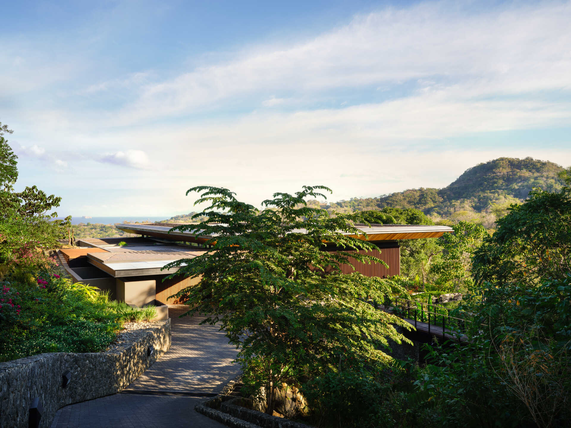 See how Casa Akíga uses stone, timber, and a floating roof to create a modern home shaped by Costa Rica's natural terrain.