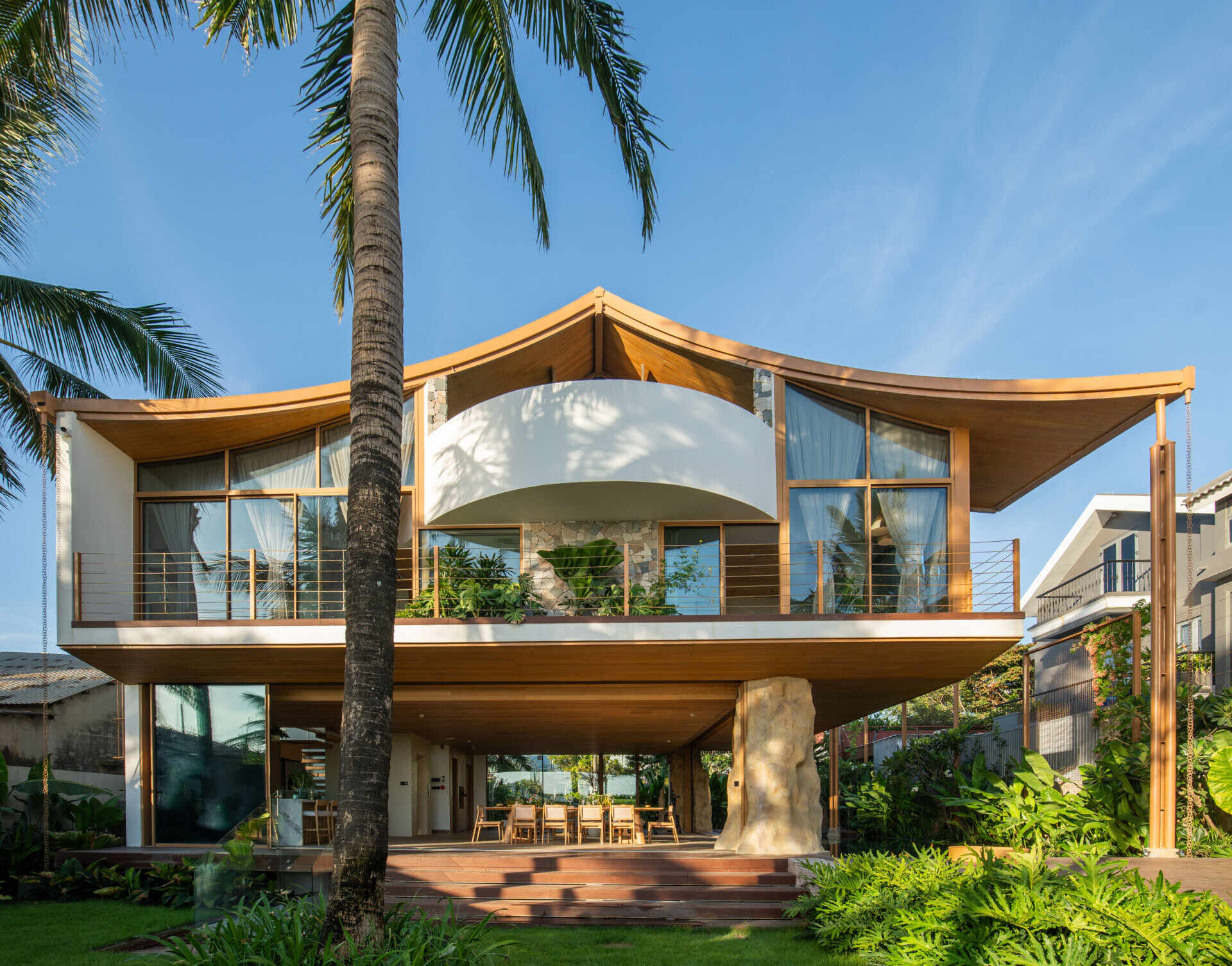 This villa's roof draws inspiration from a bird gliding above the ocean, giving the home a distinctive silhouette.
