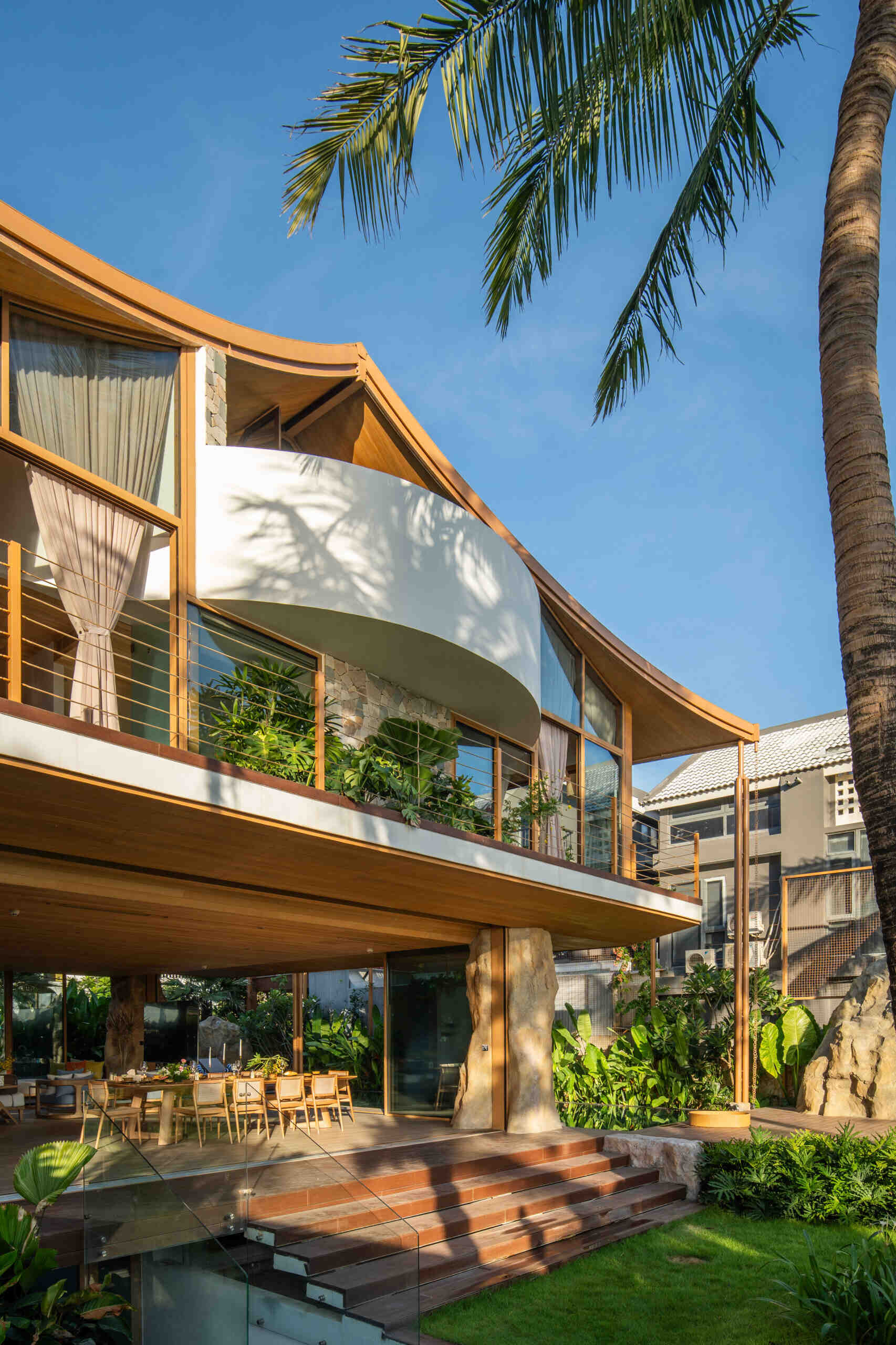 This villa's roof draws inspiration from a bird gliding above the ocean, giving the home a distinctive silhouette.