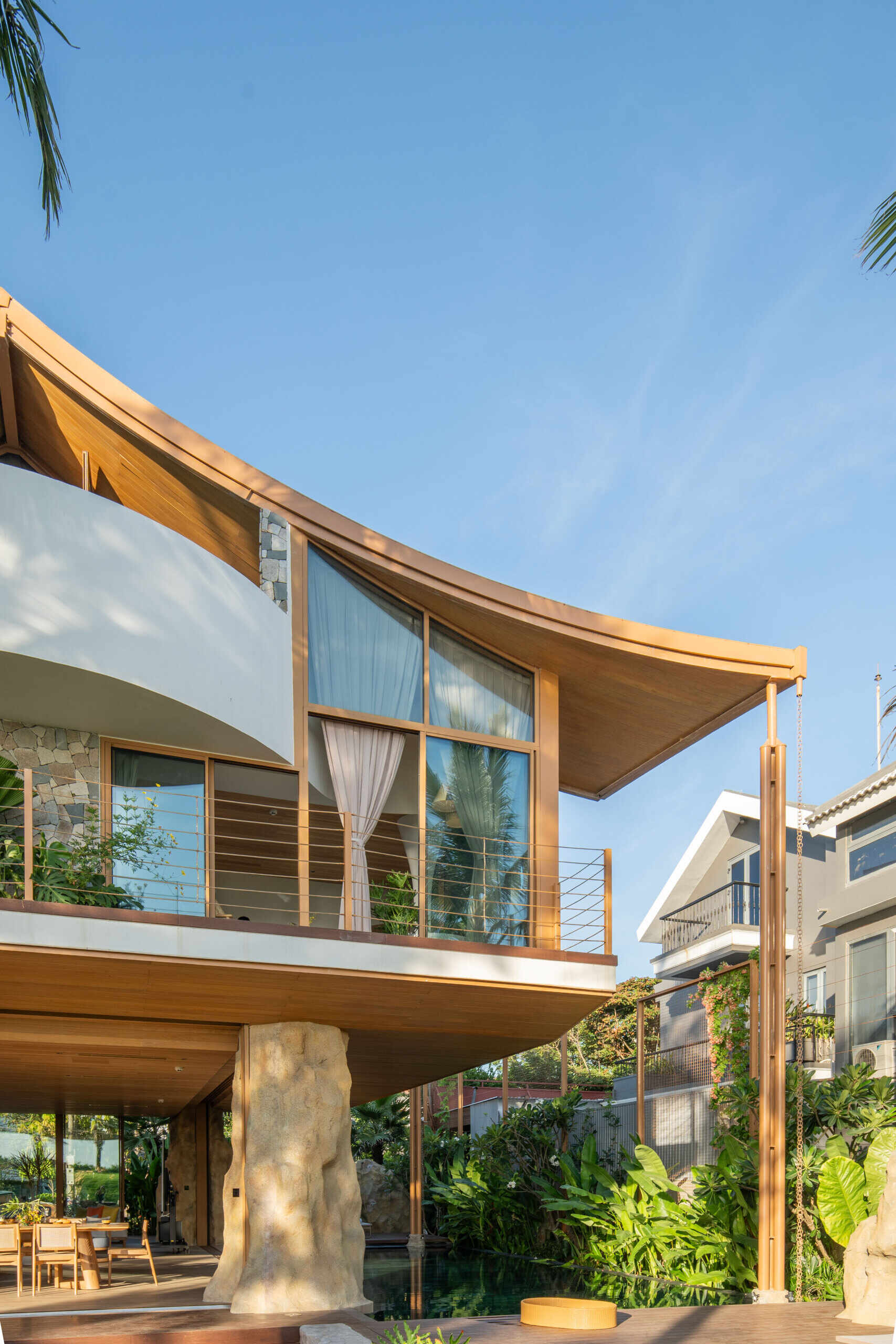 This villa's roof draws inspiration from a bird gliding above the ocean, giving the home a distinctive silhouette.