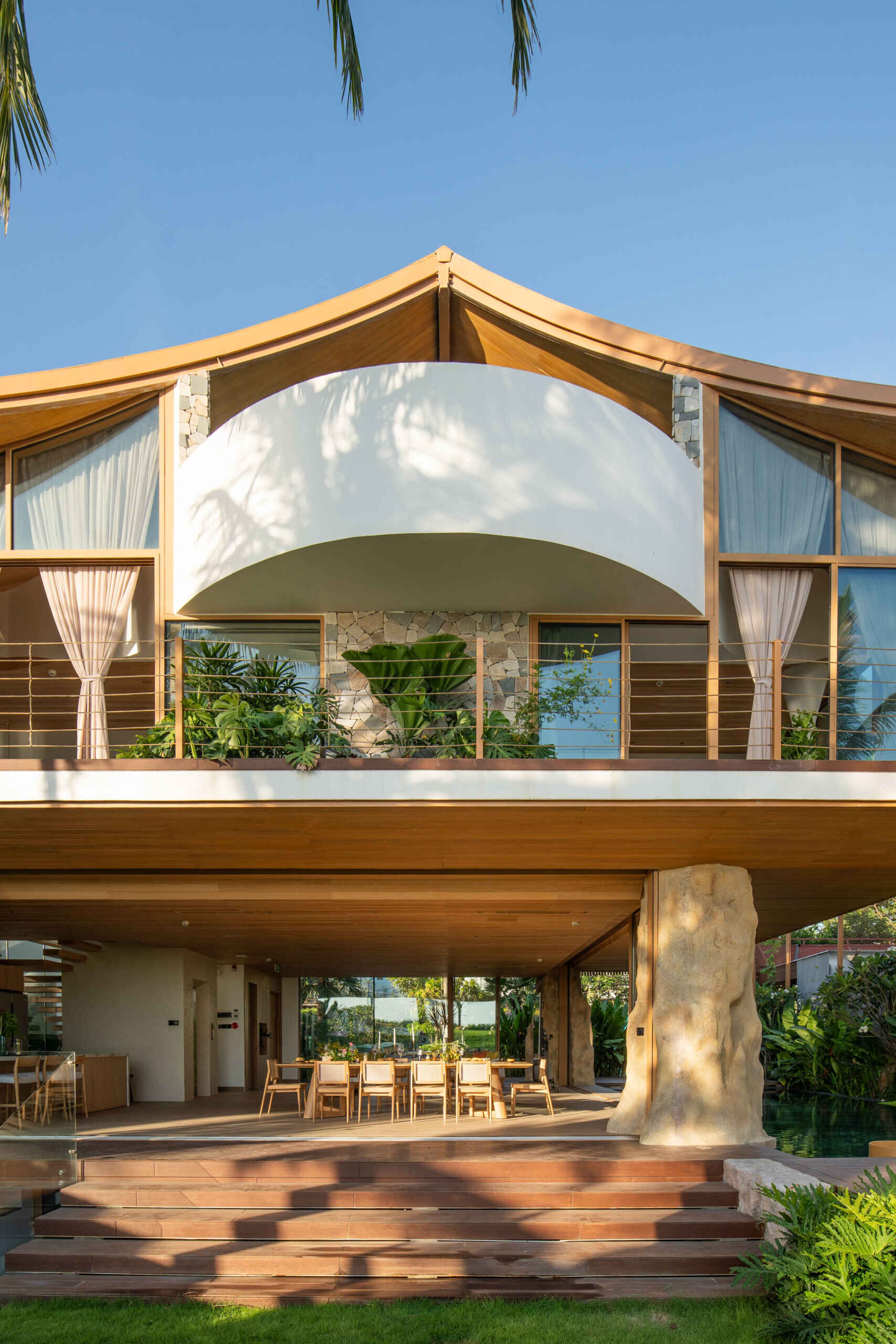 This villa's roof draws inspiration from a bird gliding above the ocean, giving the home a distinctive silhouette.