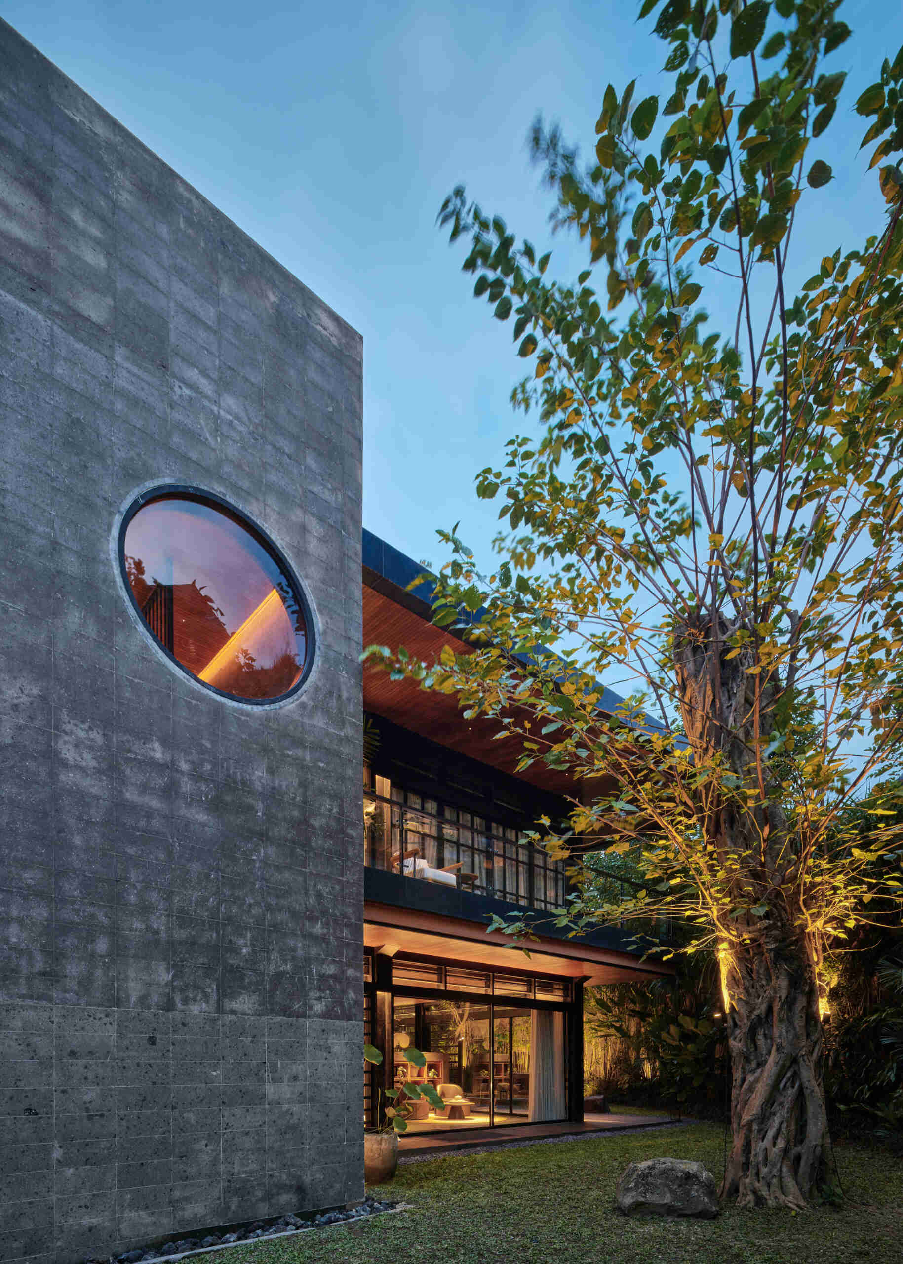 The circular opening inside Villa Suki's volcanic stone staircase is one of the home's most unforgettable architectural details.