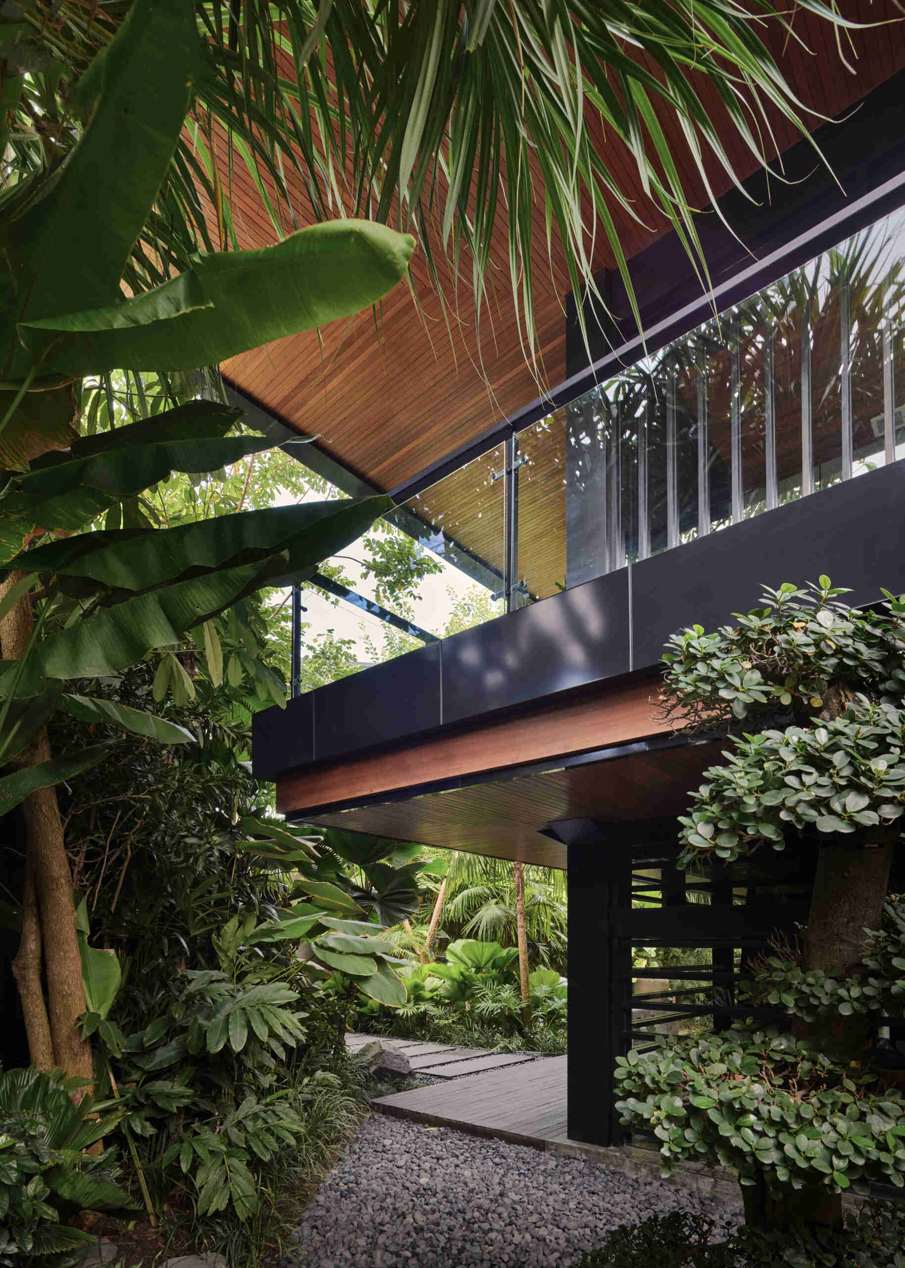 Gardens and winding pathways surround Villa Suki, creating beautiful outdoor spaces at every edge of the home.