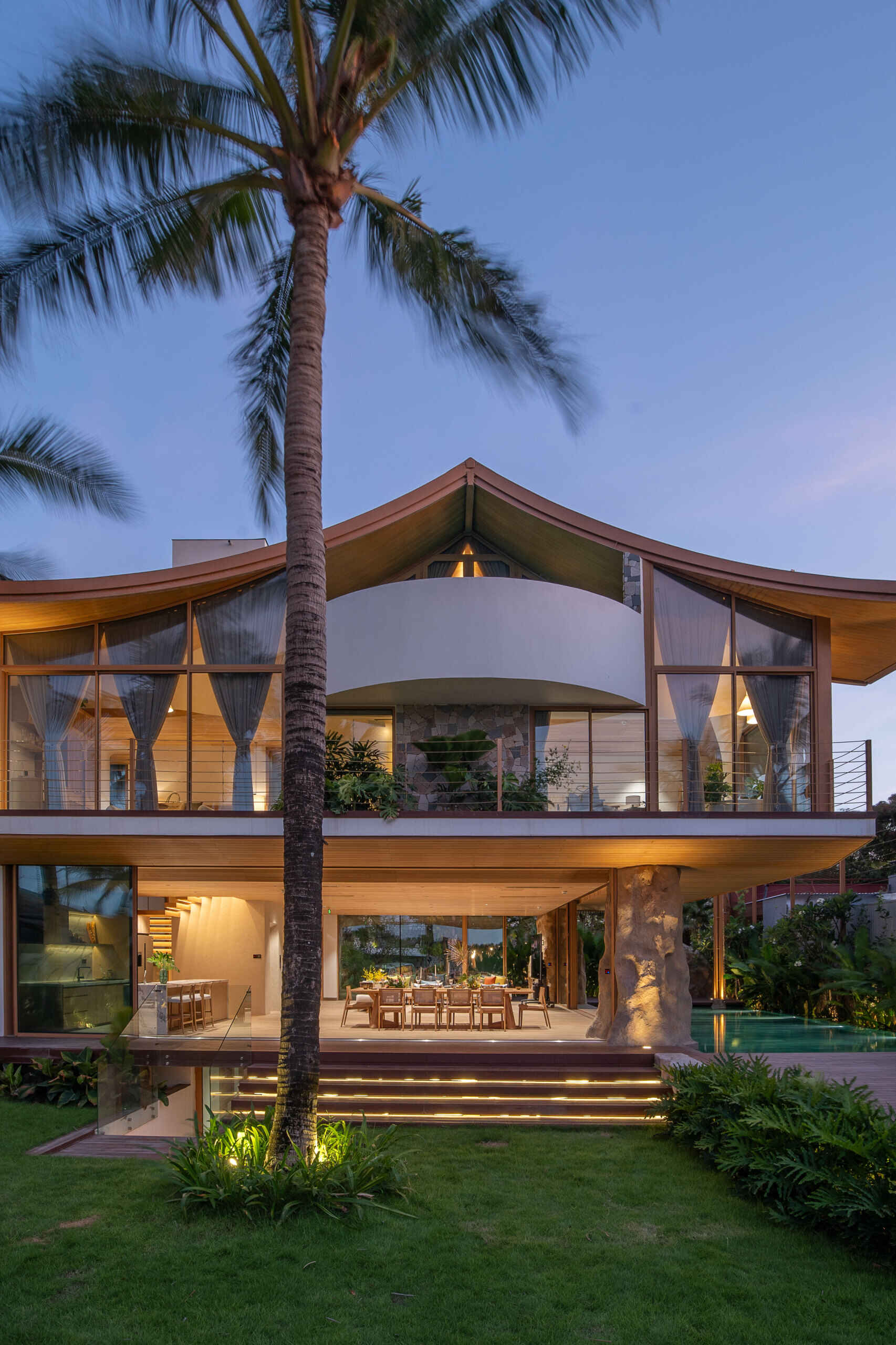 This villa's roof draws inspiration from a bird gliding above the ocean, giving the home a distinctive silhouette.