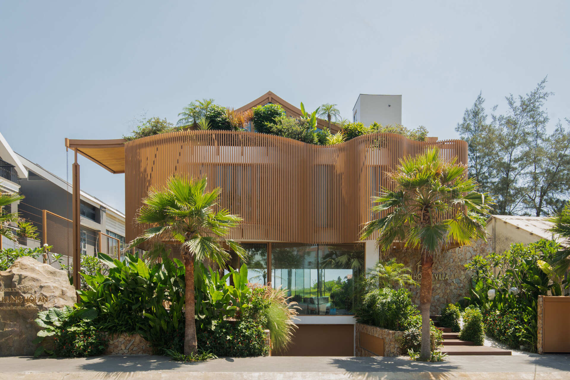 The sculptural façade, basement garage and wave-inspired louver system give TH Villa Hoi An a distinctive coastal identity while responding to the tropical climate.