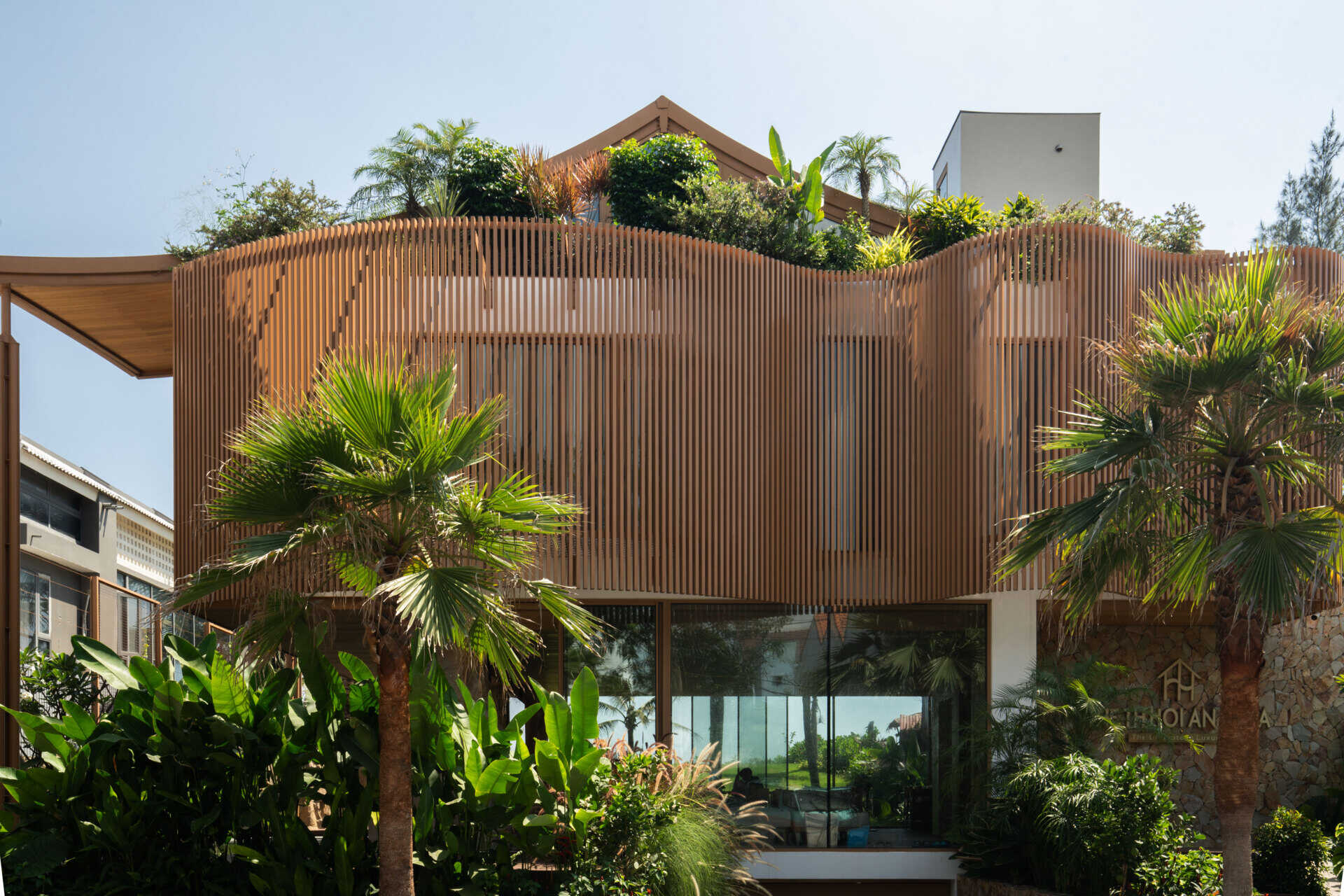 The sculptural façade, basement garage and wave-inspired louver system give TH Villa Hoi An a distinctive coastal identity while responding to the tropical climate.