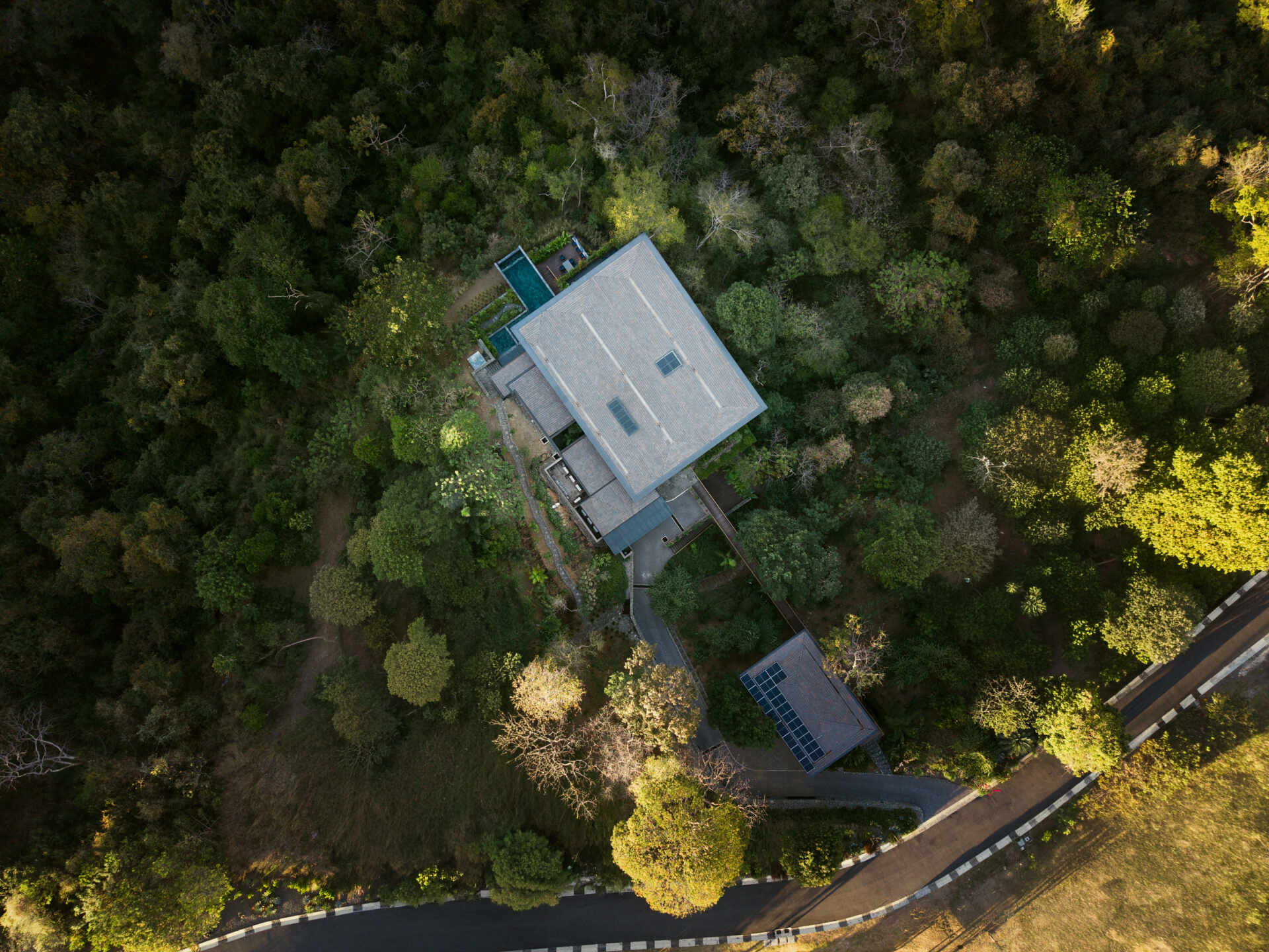 See how Casa Akíga uses stone, timber, and a floating roof to create a modern home shaped by Costa Rica's natural terrain.