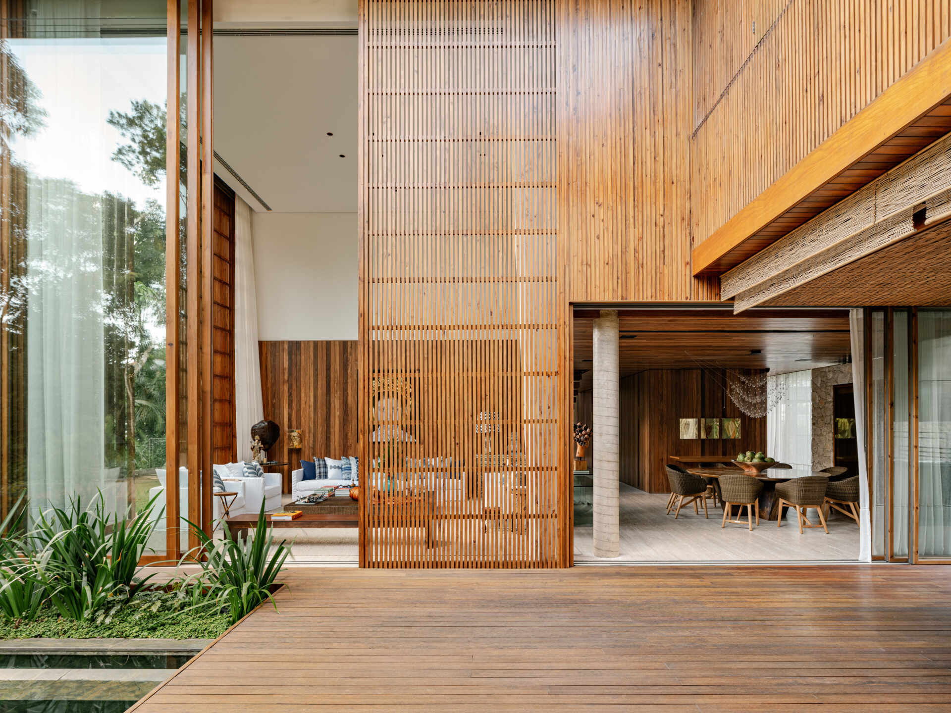 Large sliding glass walls allow this beach house to transform into one continuous indoor-outdoor entertaining space.