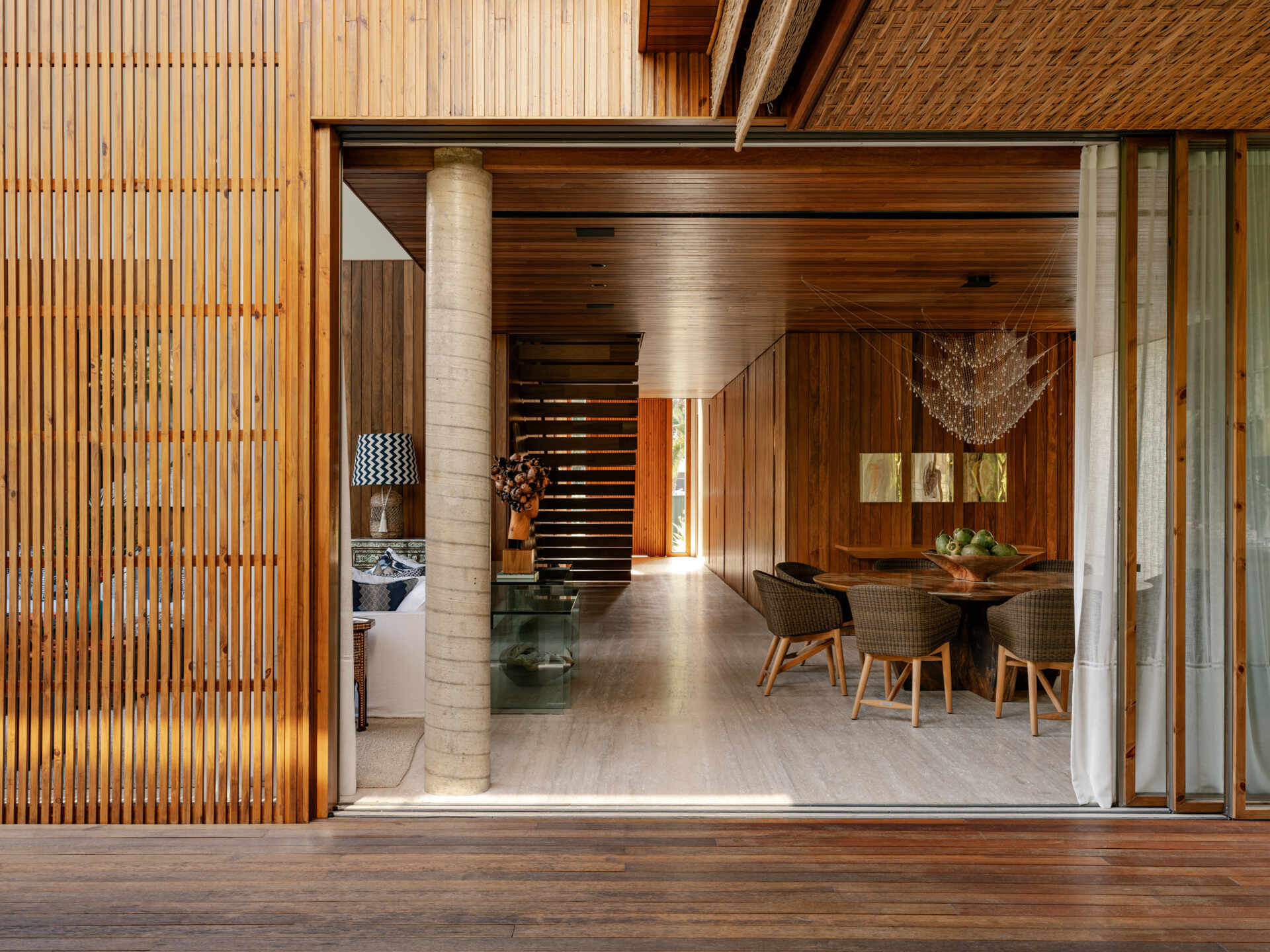 Large sliding glass walls allow this beach house to transform into one continuous indoor-outdoor entertaining space.