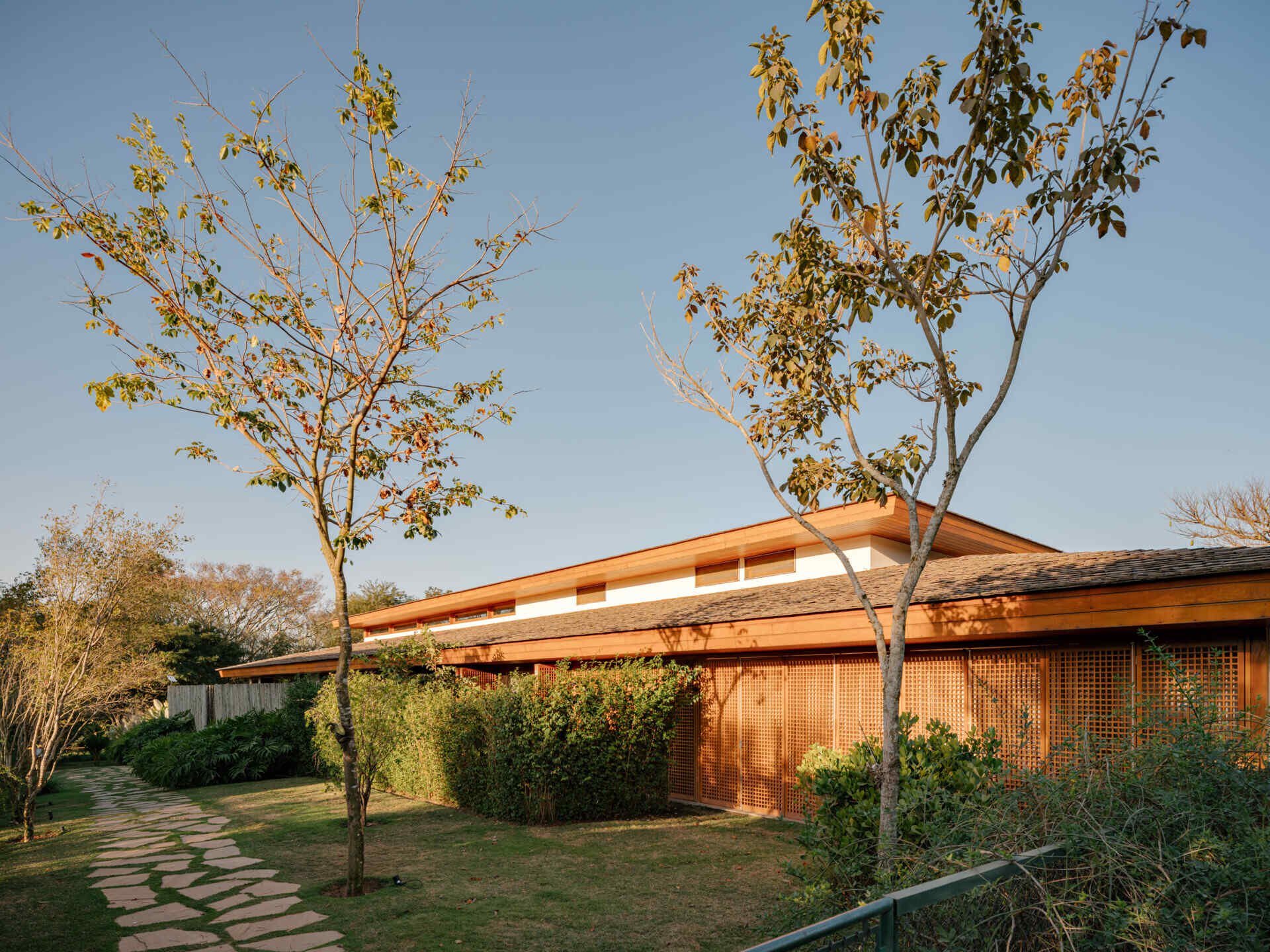 Discover how timber, concrete, basalt and straw combine to give this Brazilian country house its warm contemporary character.
