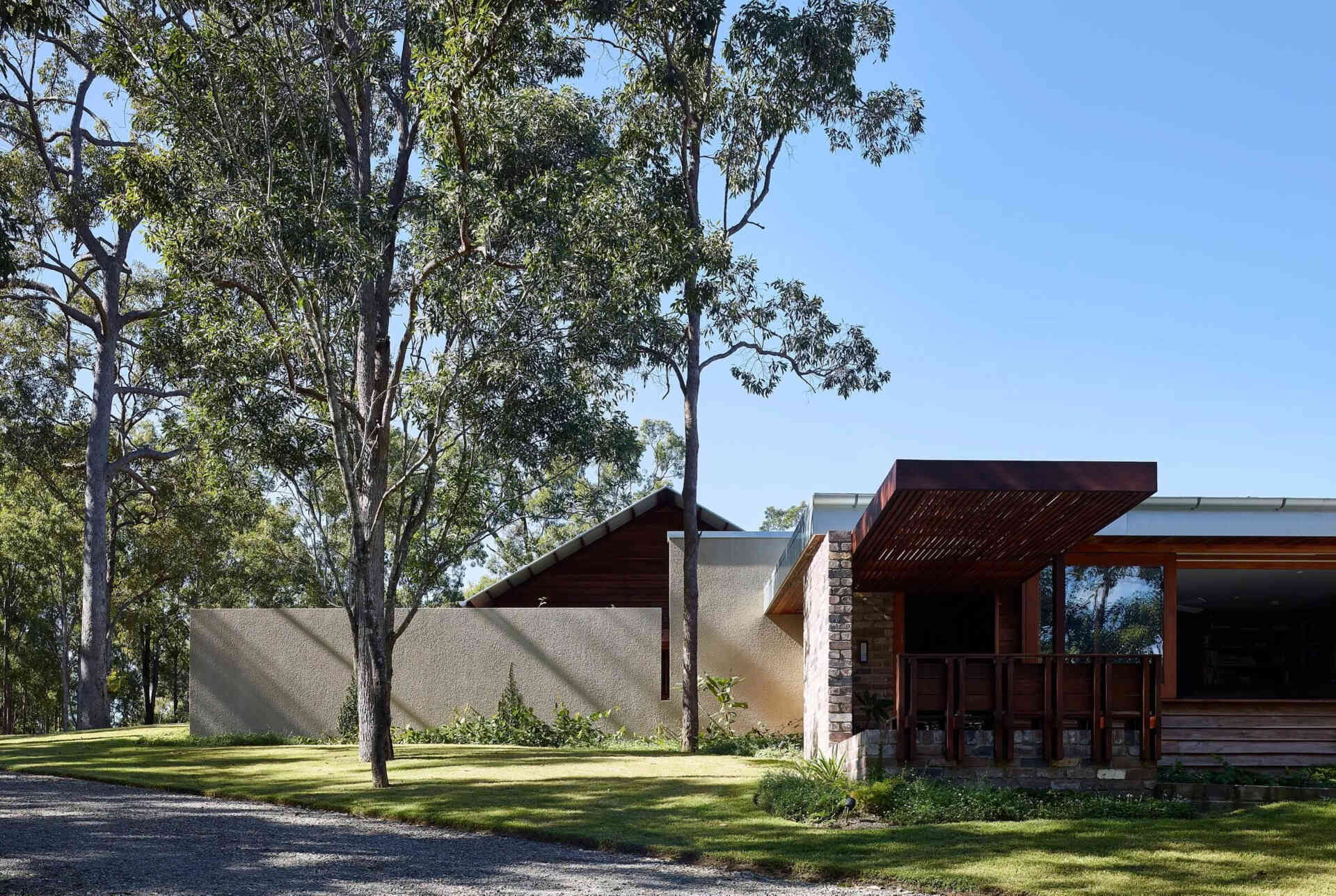 Take a tour of Greenhouse by Shaun Lockyer Architects, a warm Australian family home outside Brisbane with brick, timber and beautiful bushland views.