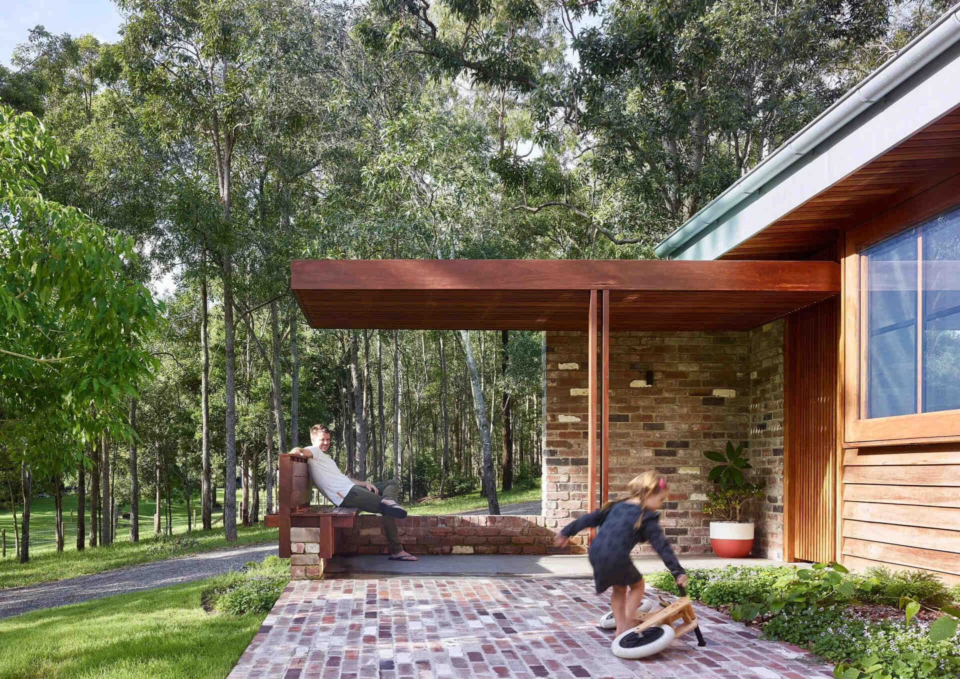 Take a tour of Greenhouse by Shaun Lockyer Architects, a warm Australian family home outside Brisbane with brick, timber and beautiful bushland views.
