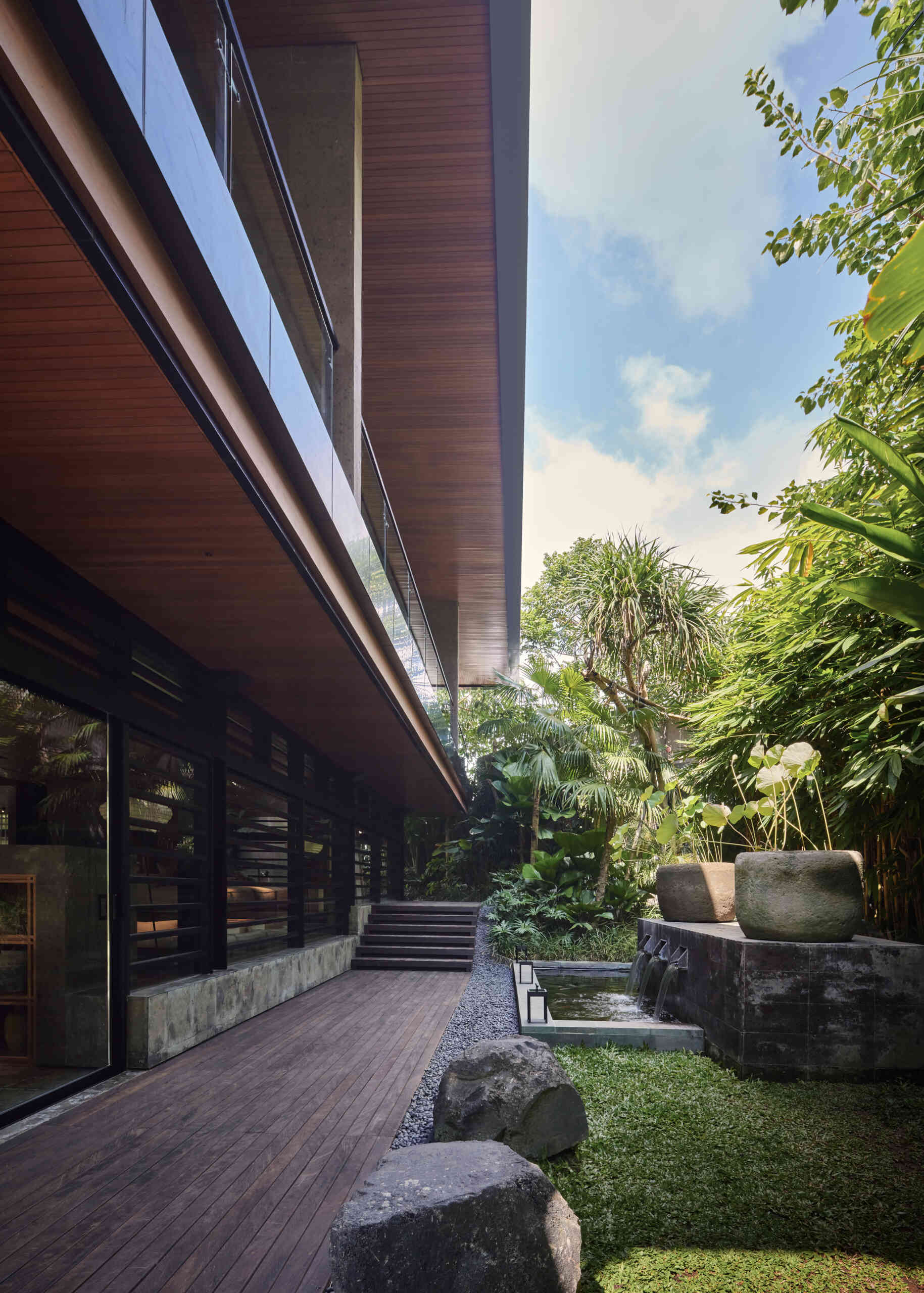Gardens and winding pathways surround Villa Suki, creating beautiful outdoor spaces at every edge of the home.