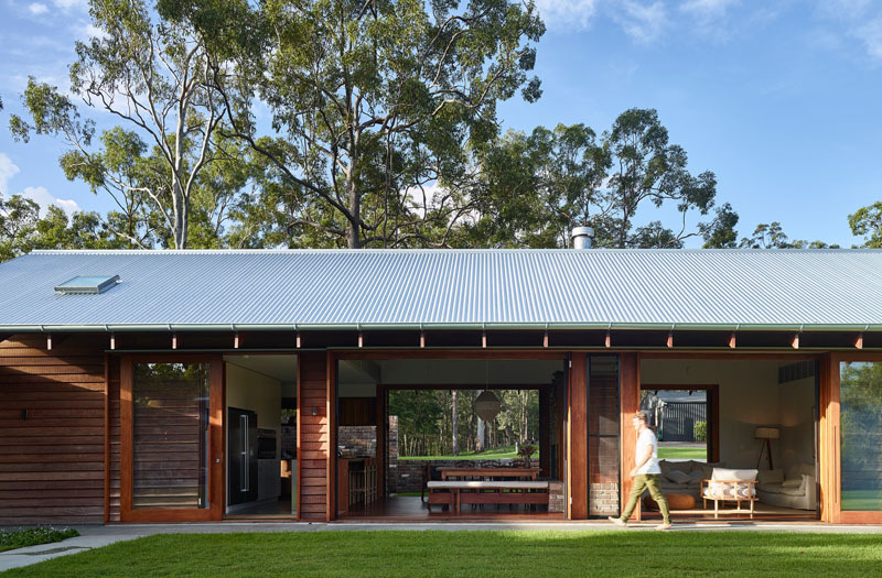 Large timber-framed sliding doors blur the line between indoors and outdoors in this beautiful Australian home.