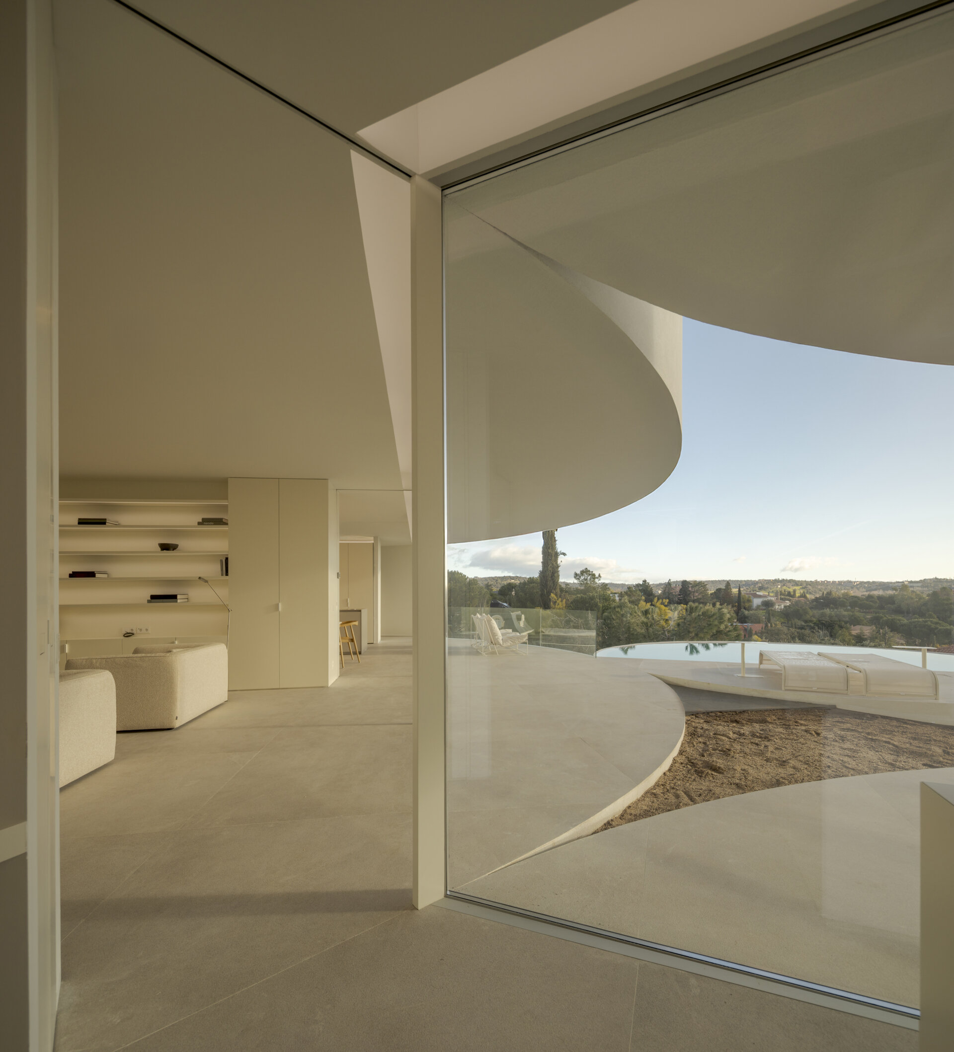 Large glass walls frame spectacular views of the Sierra de Guadarrama while filling this contemporary home with natural light.