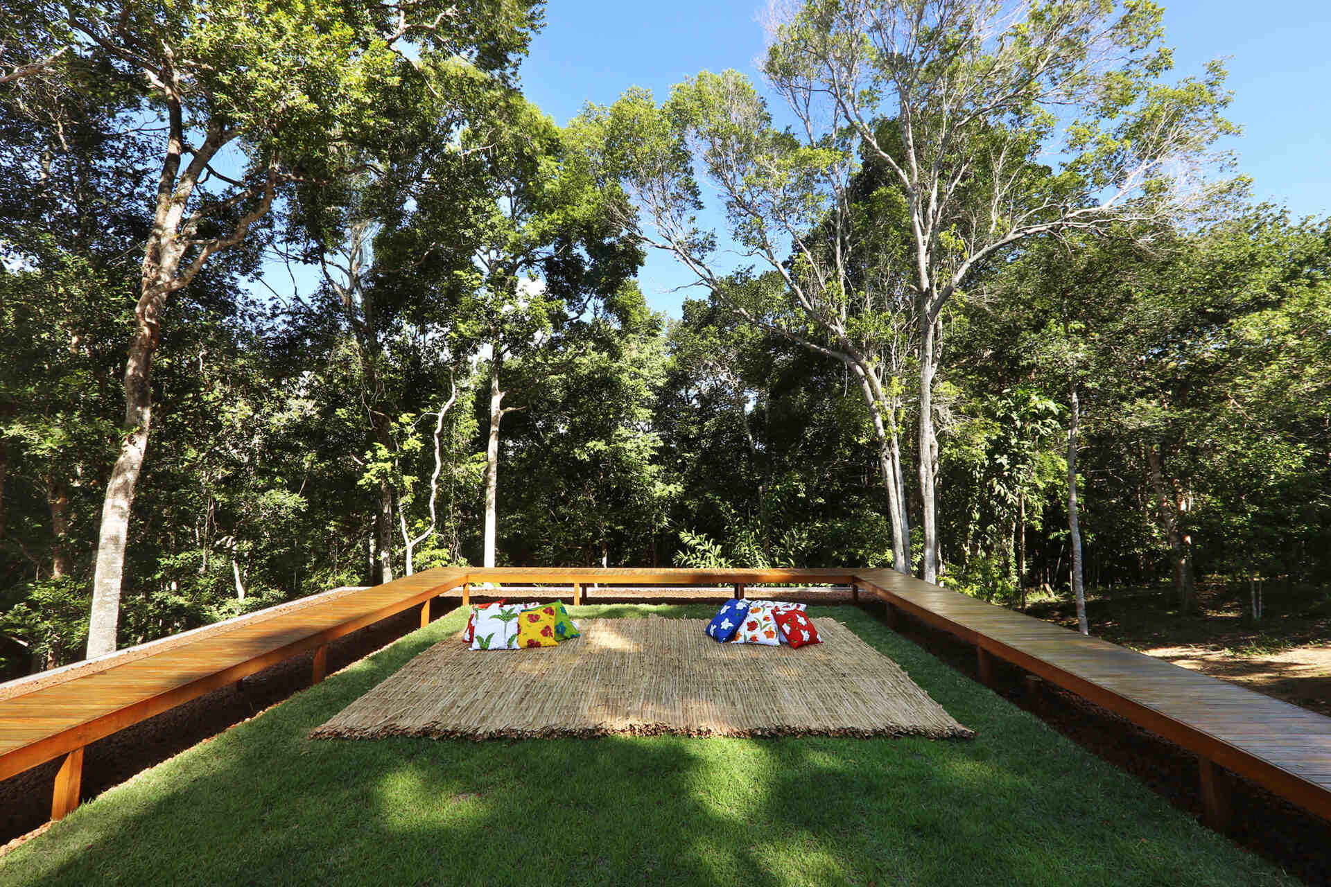 An infinity pool floats above the Atlantic Forest while a generous timber deck and wraparound bench create the perfect outdoor entertaining space.