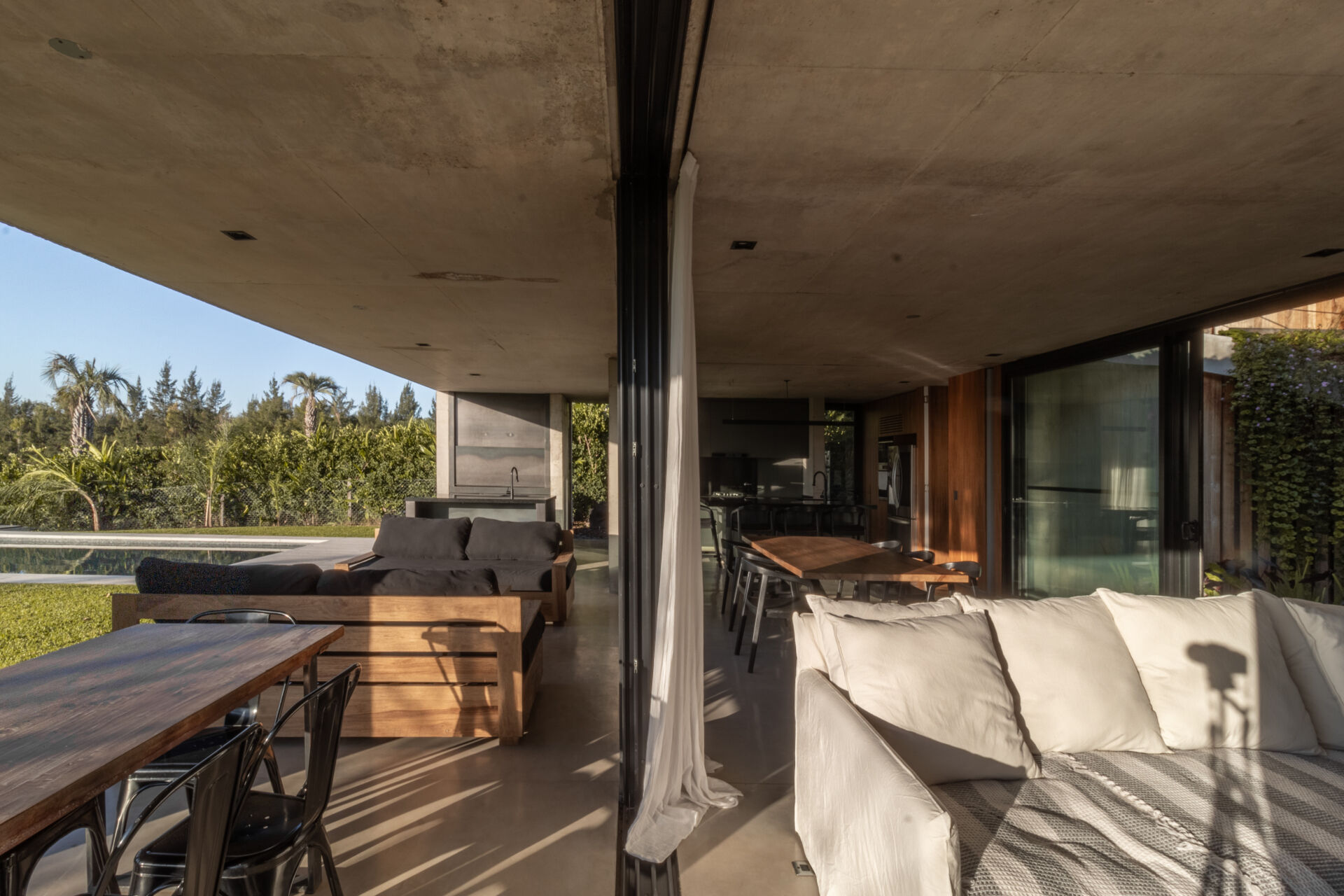 Tour the covered patio, outdoor kitchen, and pool area that make entertaining effortless in this modern Buenos Aires home.