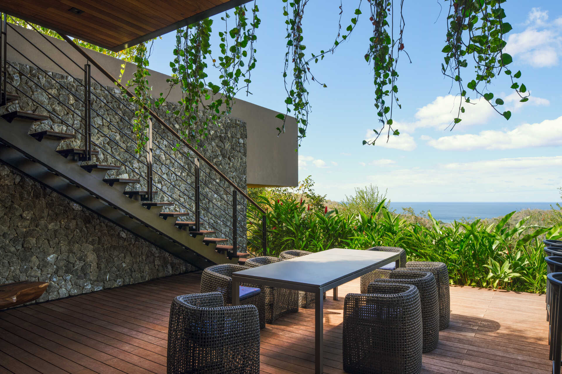 Covered lounges, dining spaces, and sweeping views make this terrace ideal for entertaining in Costa Rica's tropical climate.