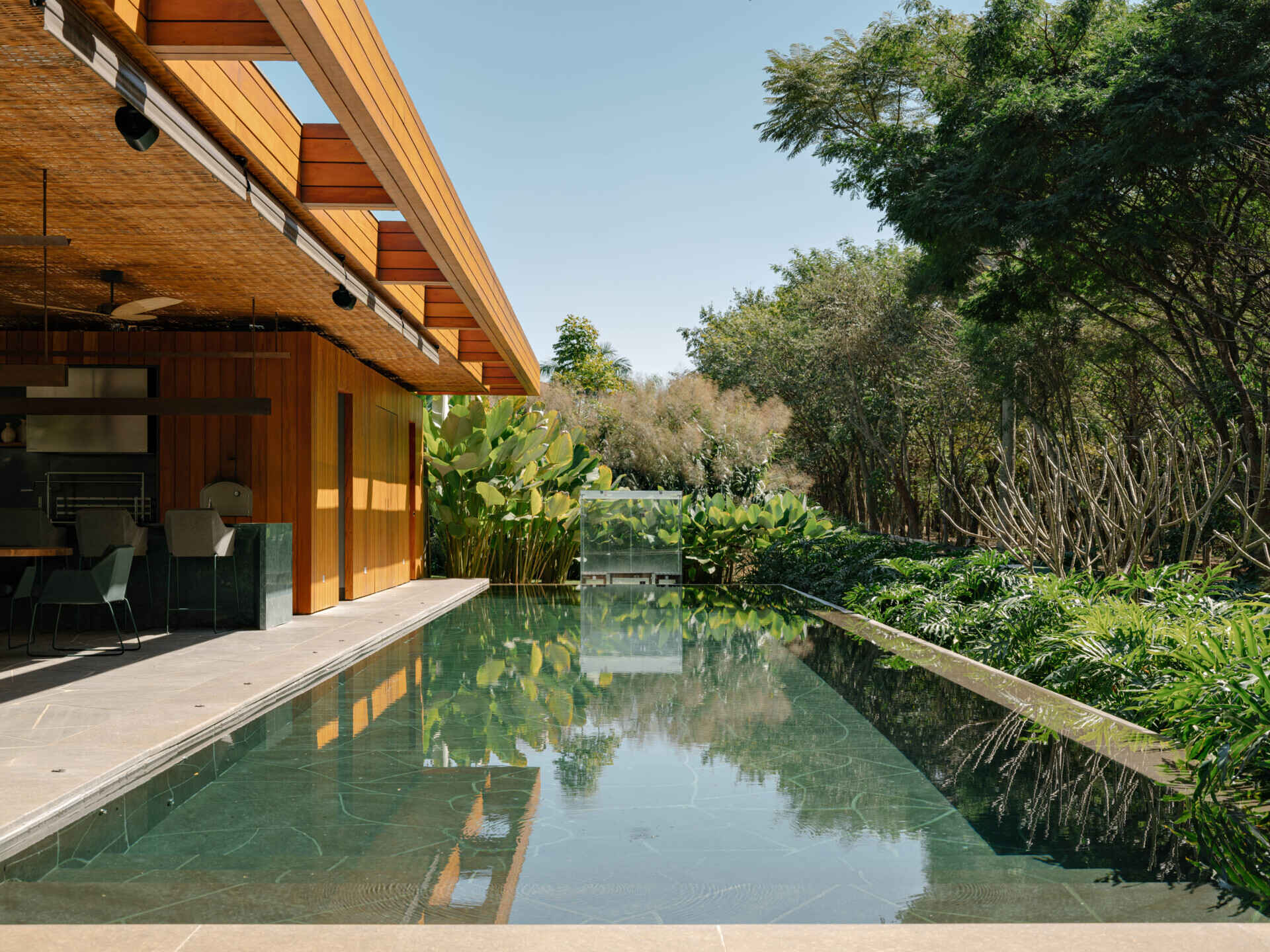Natural stone and warm outdoor finishes make this swimming pool a standout feature of the property.