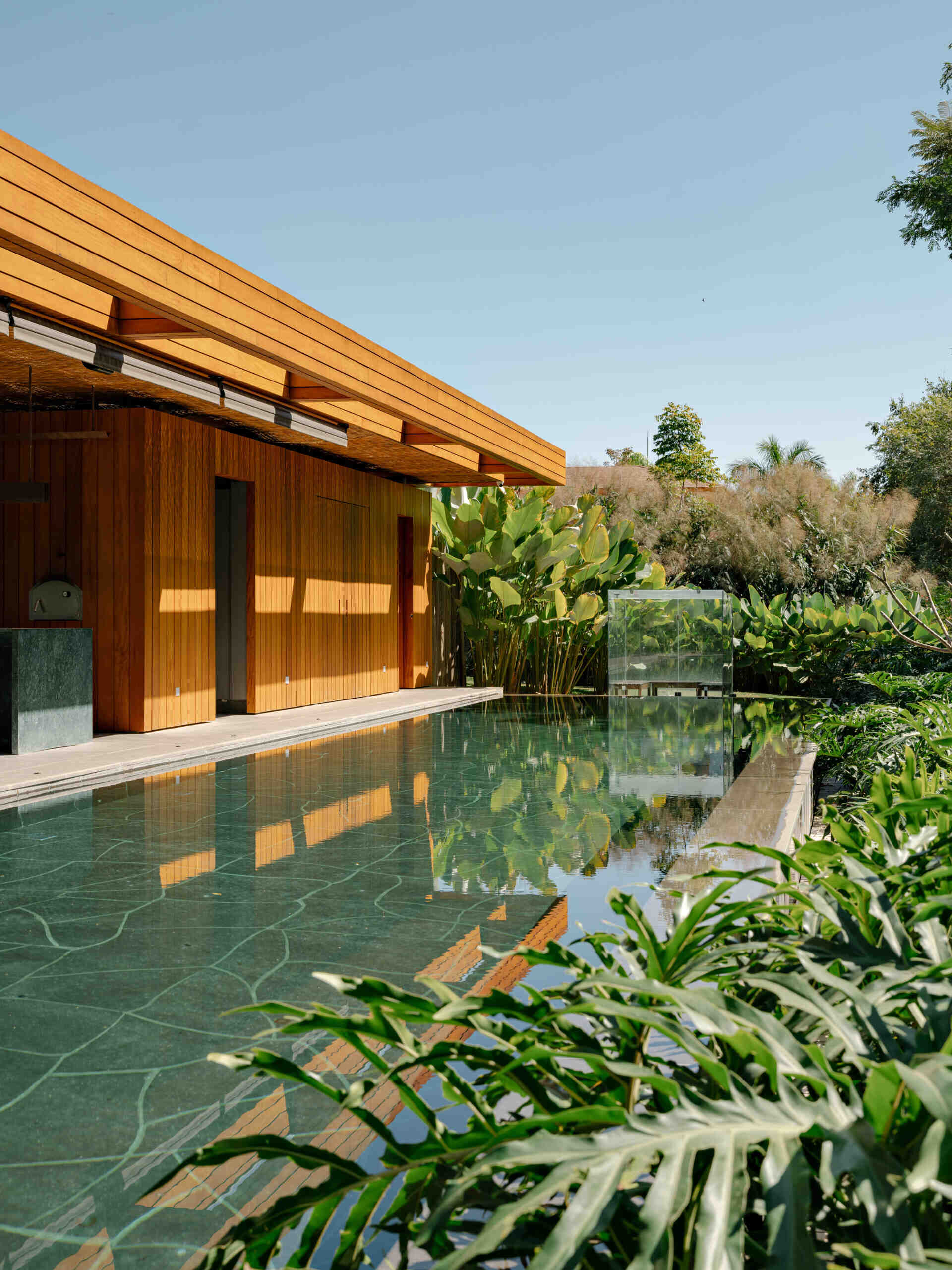 Natural stone and warm outdoor finishes make this swimming pool a standout feature of the property.