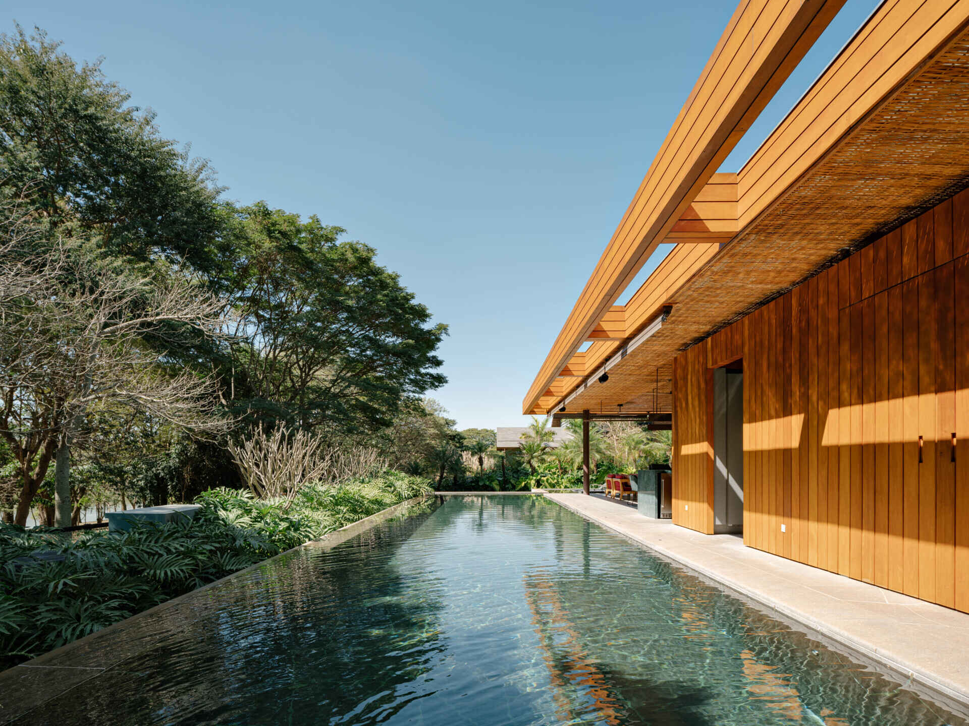 Natural stone and warm outdoor finishes make this swimming pool a standout feature of the property.