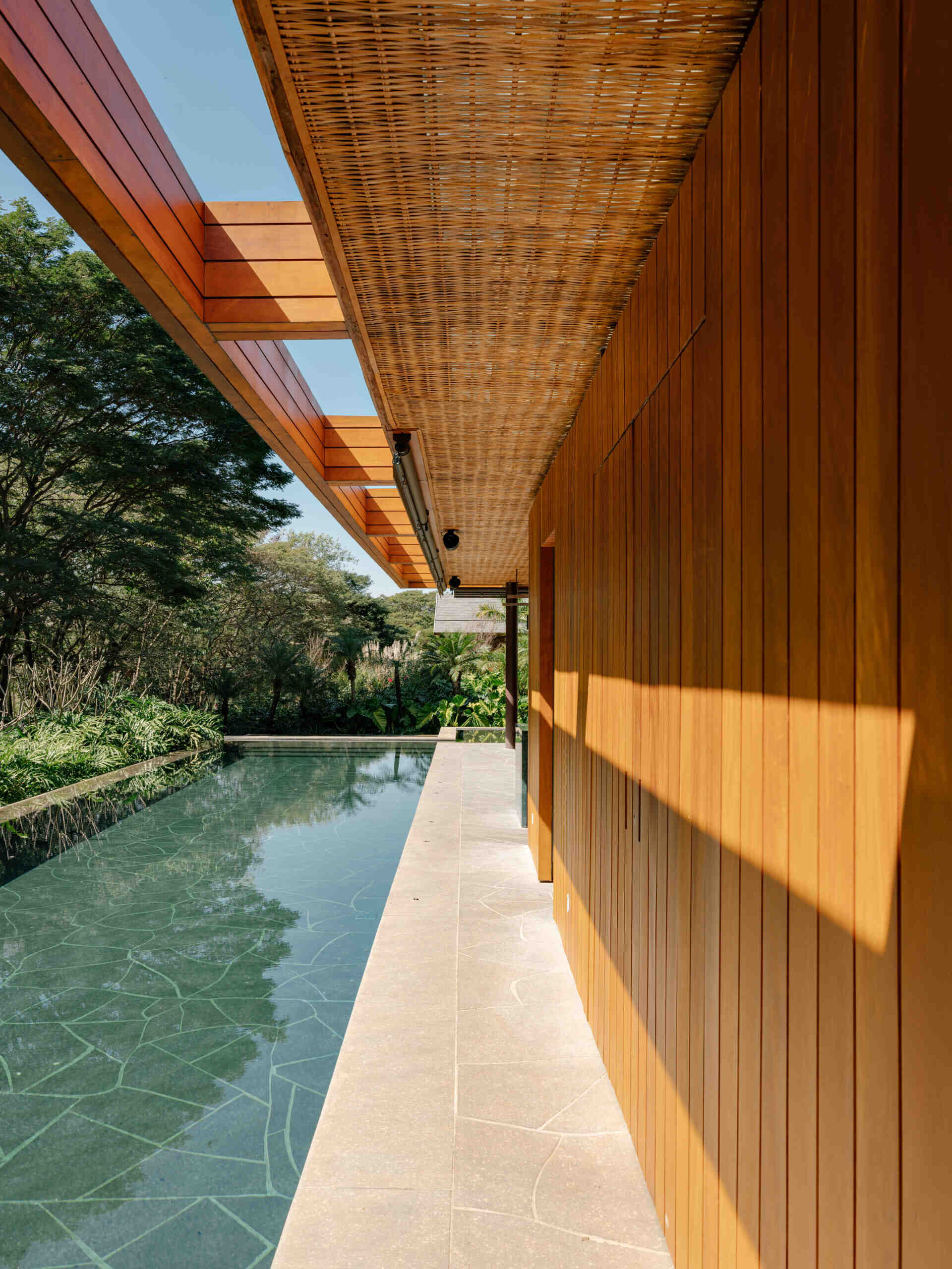 Natural stone and warm outdoor finishes make this swimming pool a standout feature of the property.