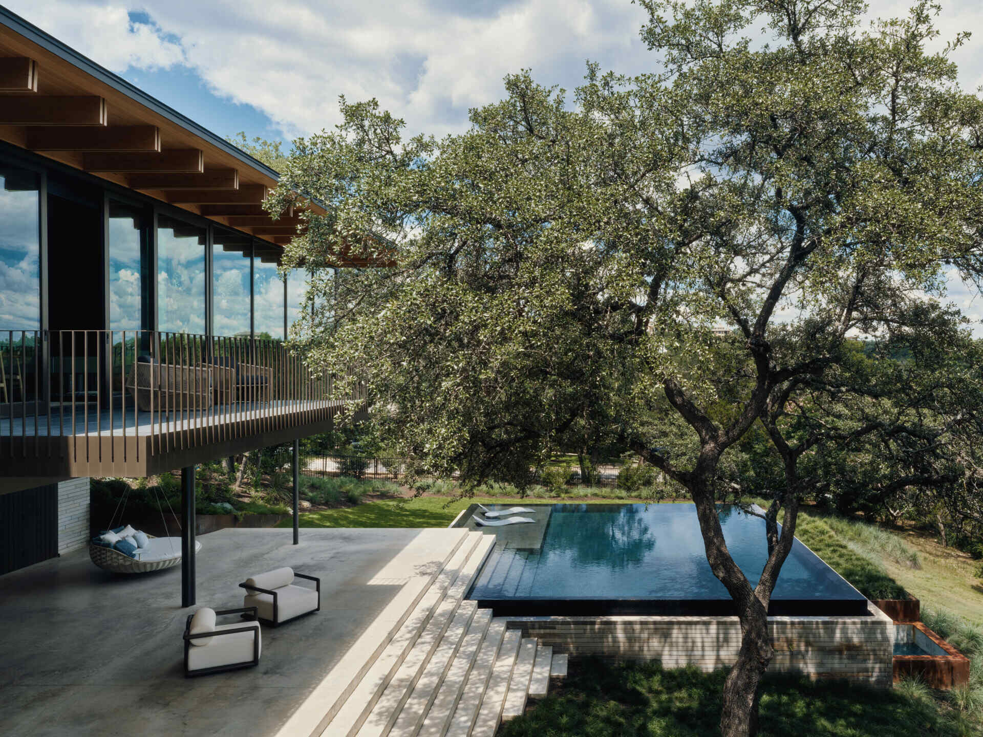 A hillside pool captures panoramic views while reflecting the home's clean architectural forms.