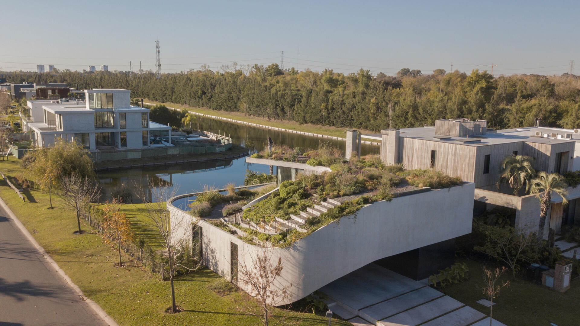 Explore the concrete architecture of GP House, featuring sculptural forms, expansive glazing, and a rooftop garden overlooking the lagoon.