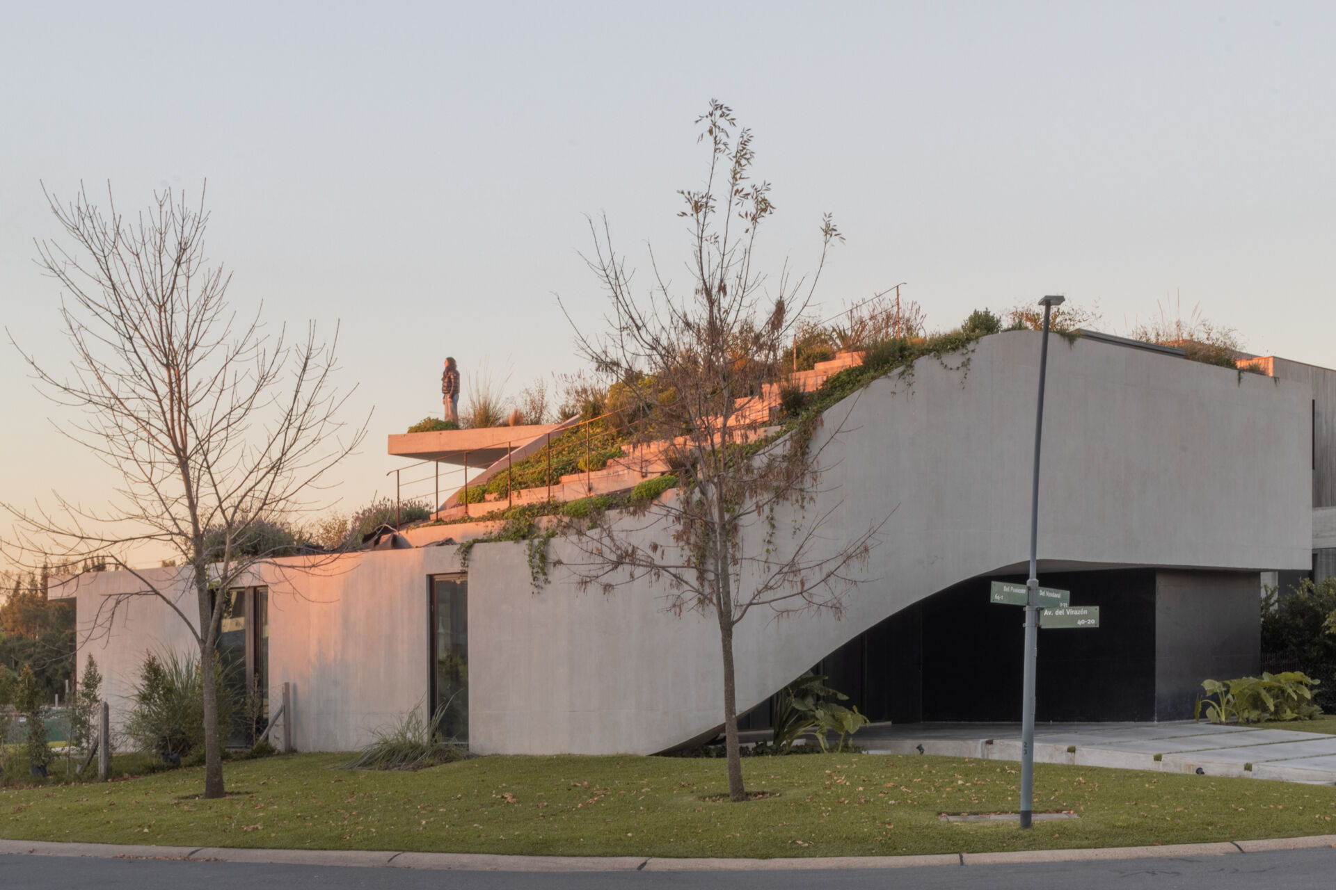 Explore the concrete architecture of GP House, featuring sculptural forms, expansive glazing, and a beautiful rooftop garden overlooking the lagoon.