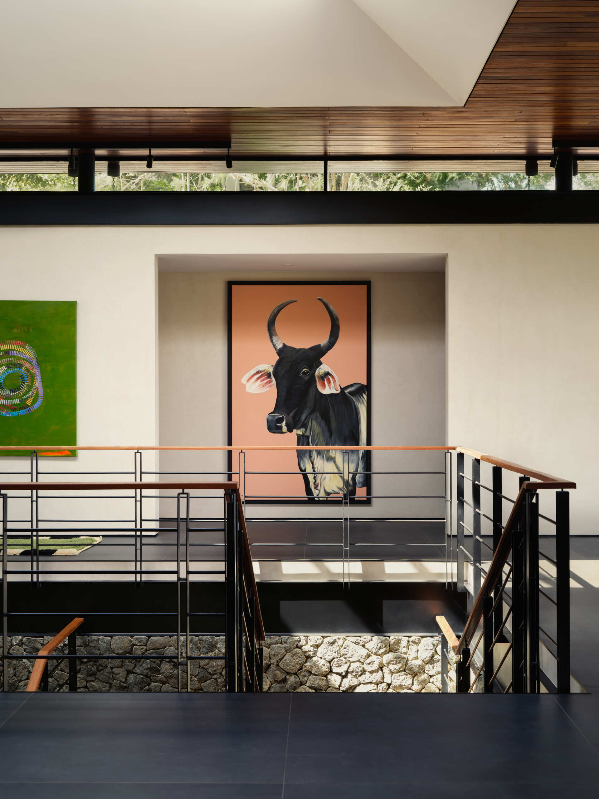 Floating timber treads, steel detailing, and lush planting transform this staircase into one of the home's standout features.