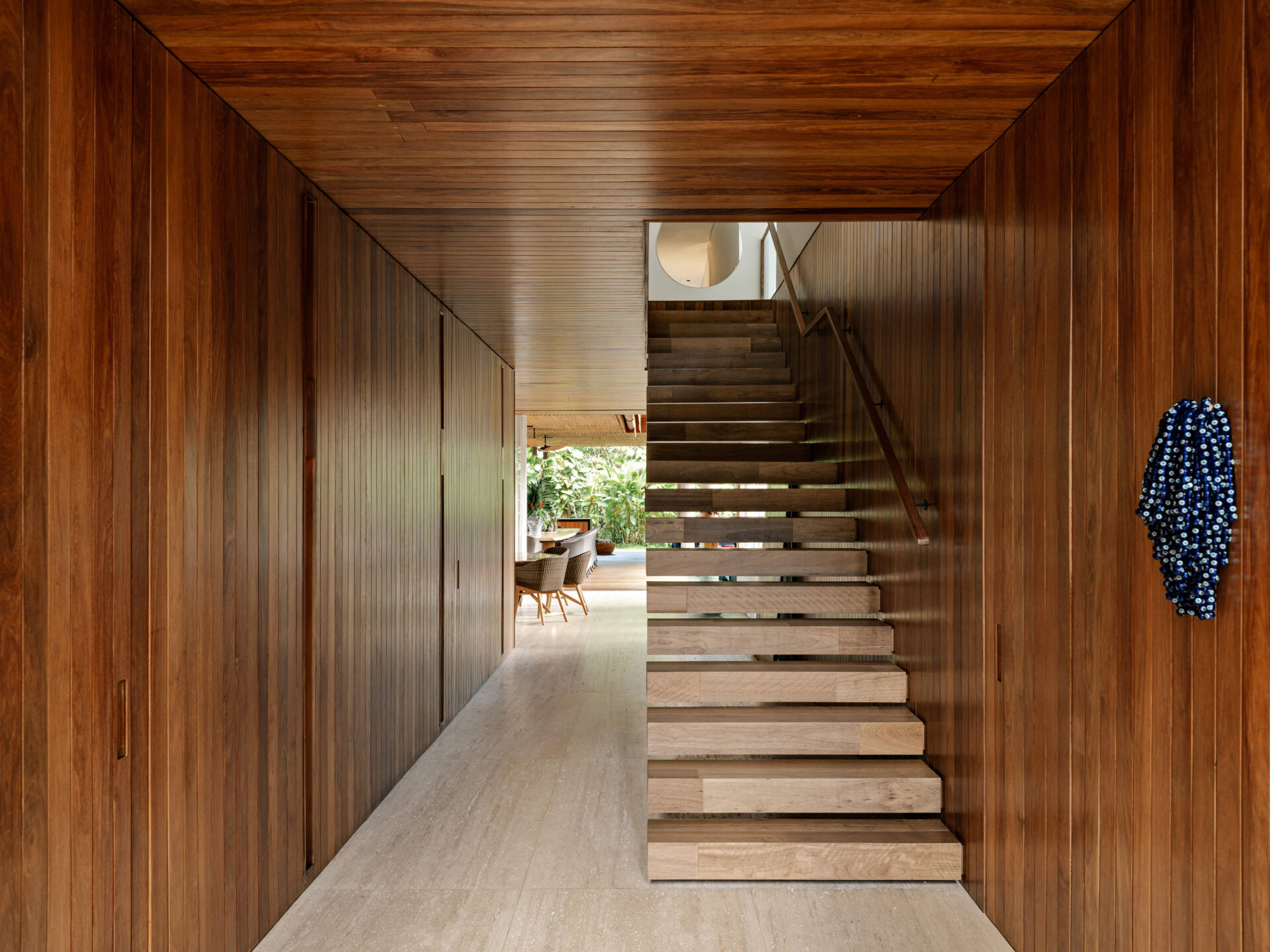 Wood stairs lead from the main living level to an open gallery hallway upstairs.
