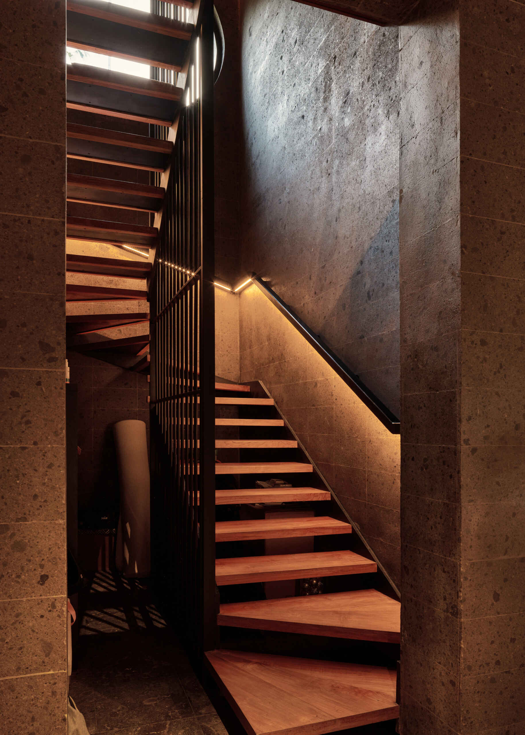 This sculptural volcanic stone staircase is much more than a connection between floors. It's one of Villa Suki's defining design features.