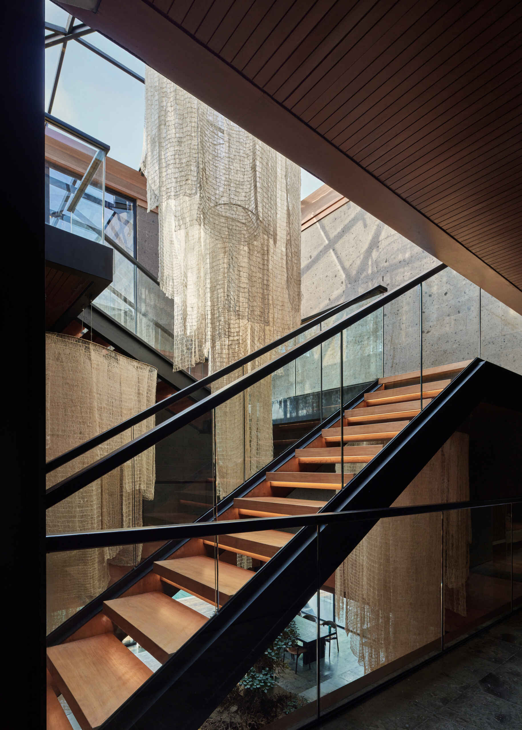 This sculptural volcanic stone staircase is much more than a connection between floors. It's one of Villa Suki's defining design features.
