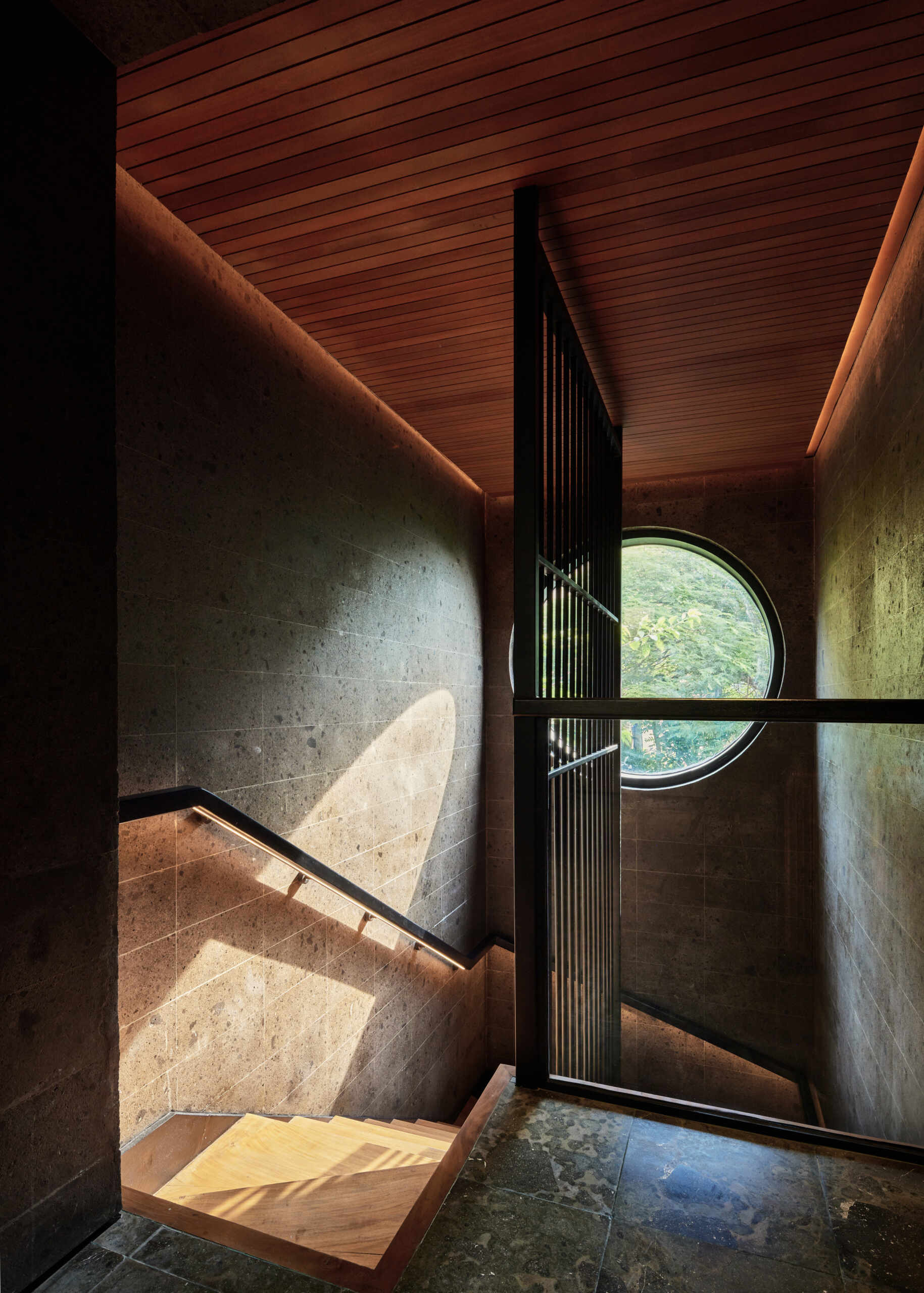 This sculptural volcanic stone staircase is much more than a connection between floors. It's one of Villa Suki's defining design features.