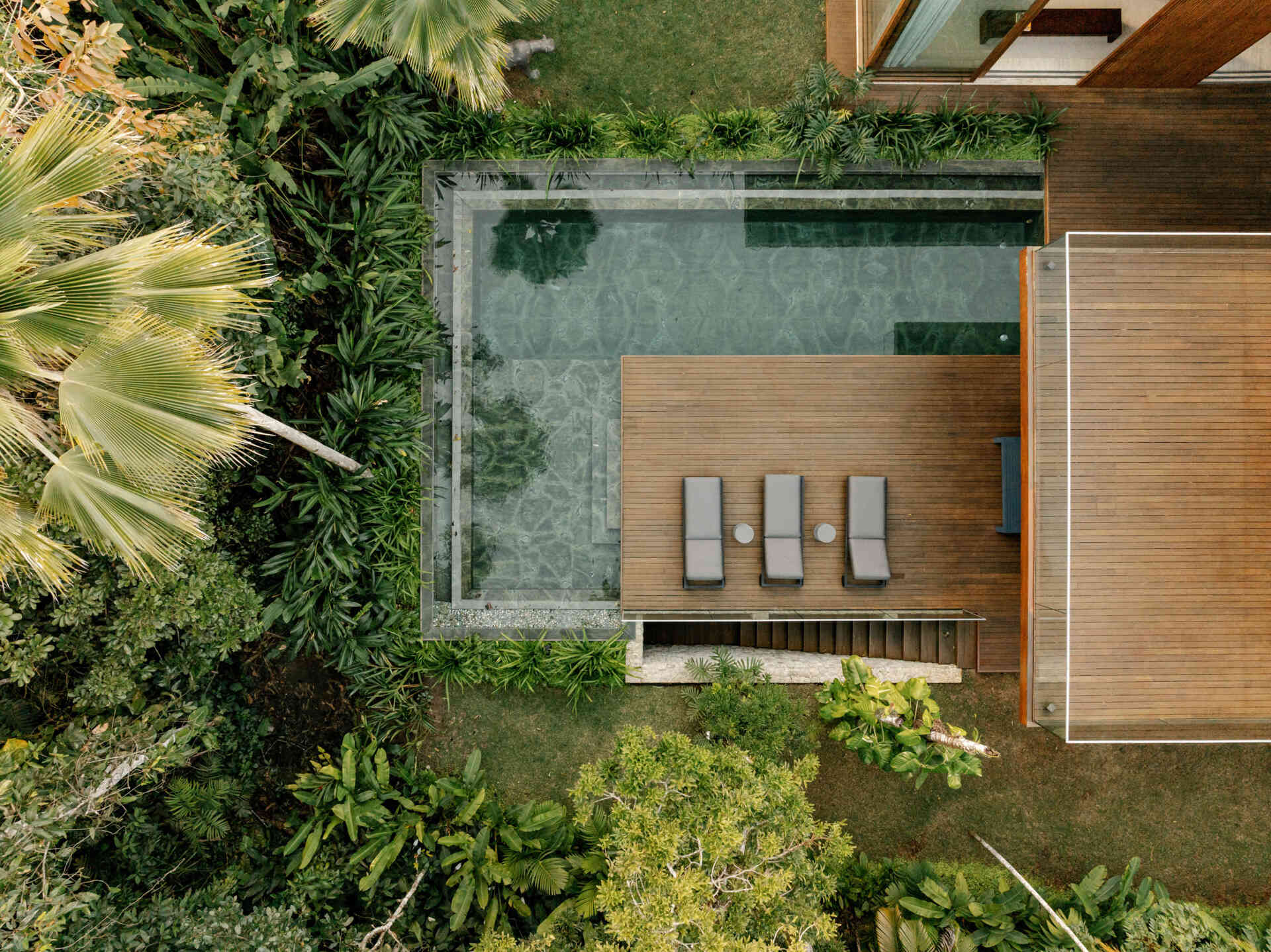 This green marble swimming pool and timber deck create one of the most beautiful outdoor spaces in the home.