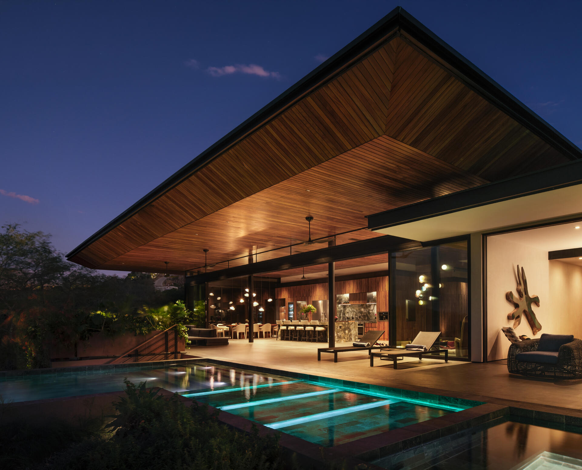 Discover the pool terrace where contemporary architecture, warm timber, and tropical planting come together in Costa Rica.