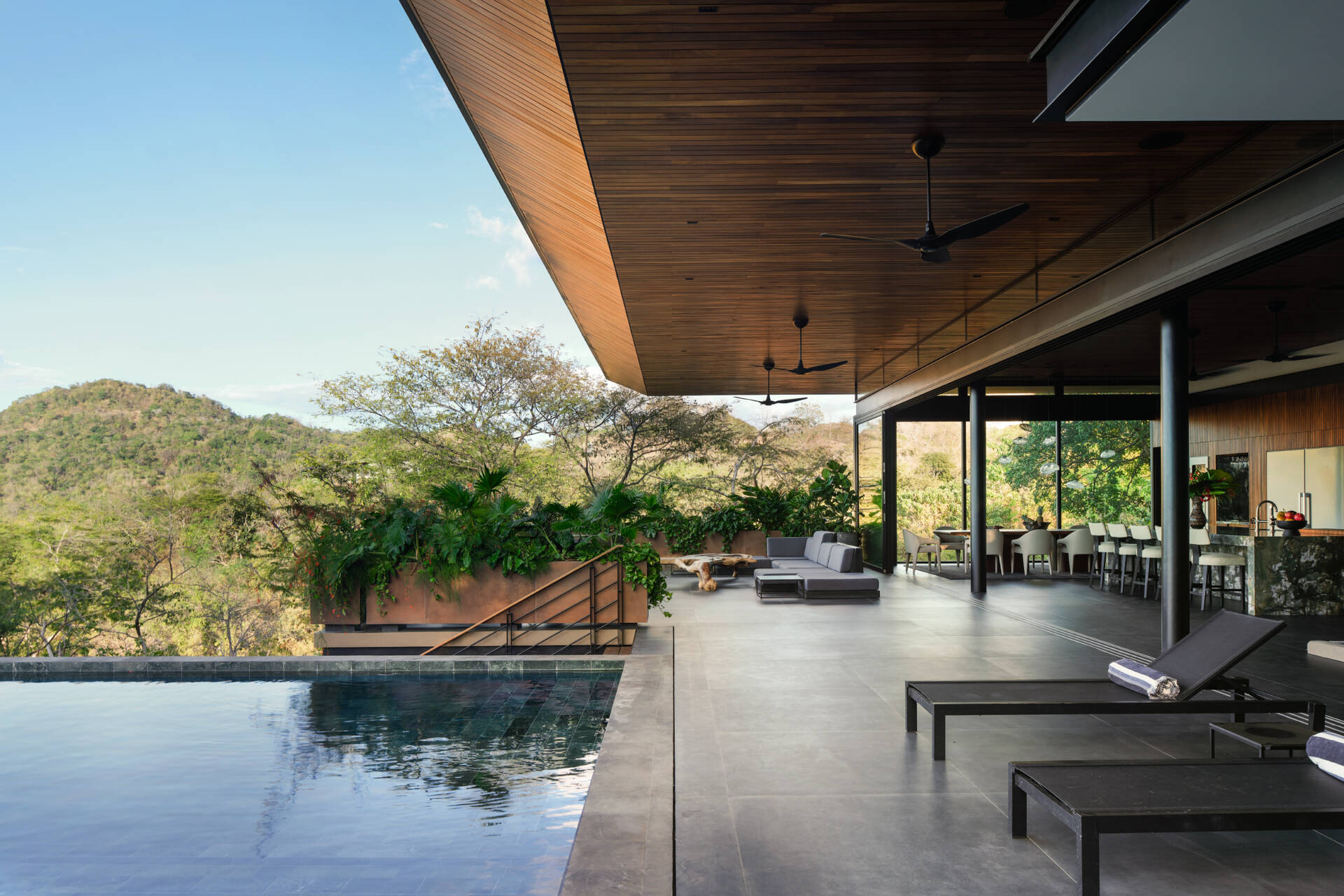 Discover the pool terrace where contemporary architecture, warm timber, and tropical planting come together in Costa Rica.