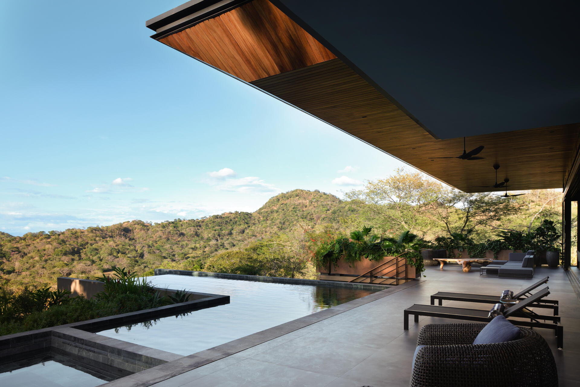 Discover the pool terrace where contemporary architecture, warm timber, and tropical planting come together in Costa Rica.