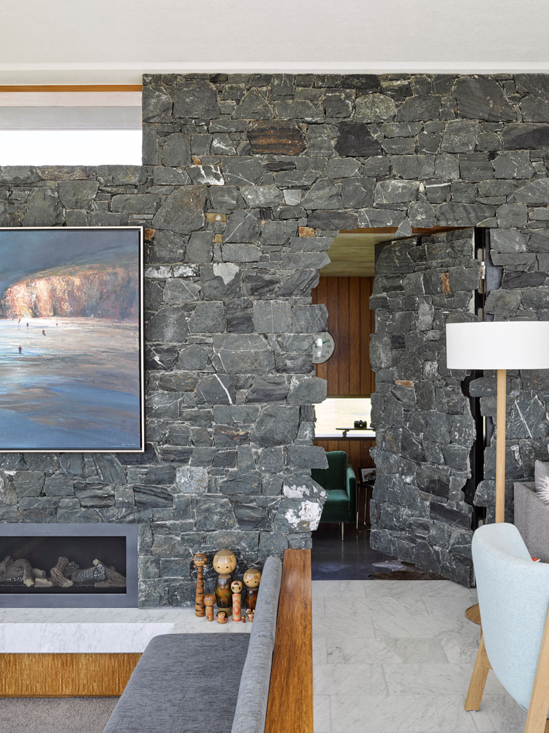 Behind this bluestone wall is a hidden home office door. A clever architectural detail that keeps the interiors clean while adding a sense of surprise.