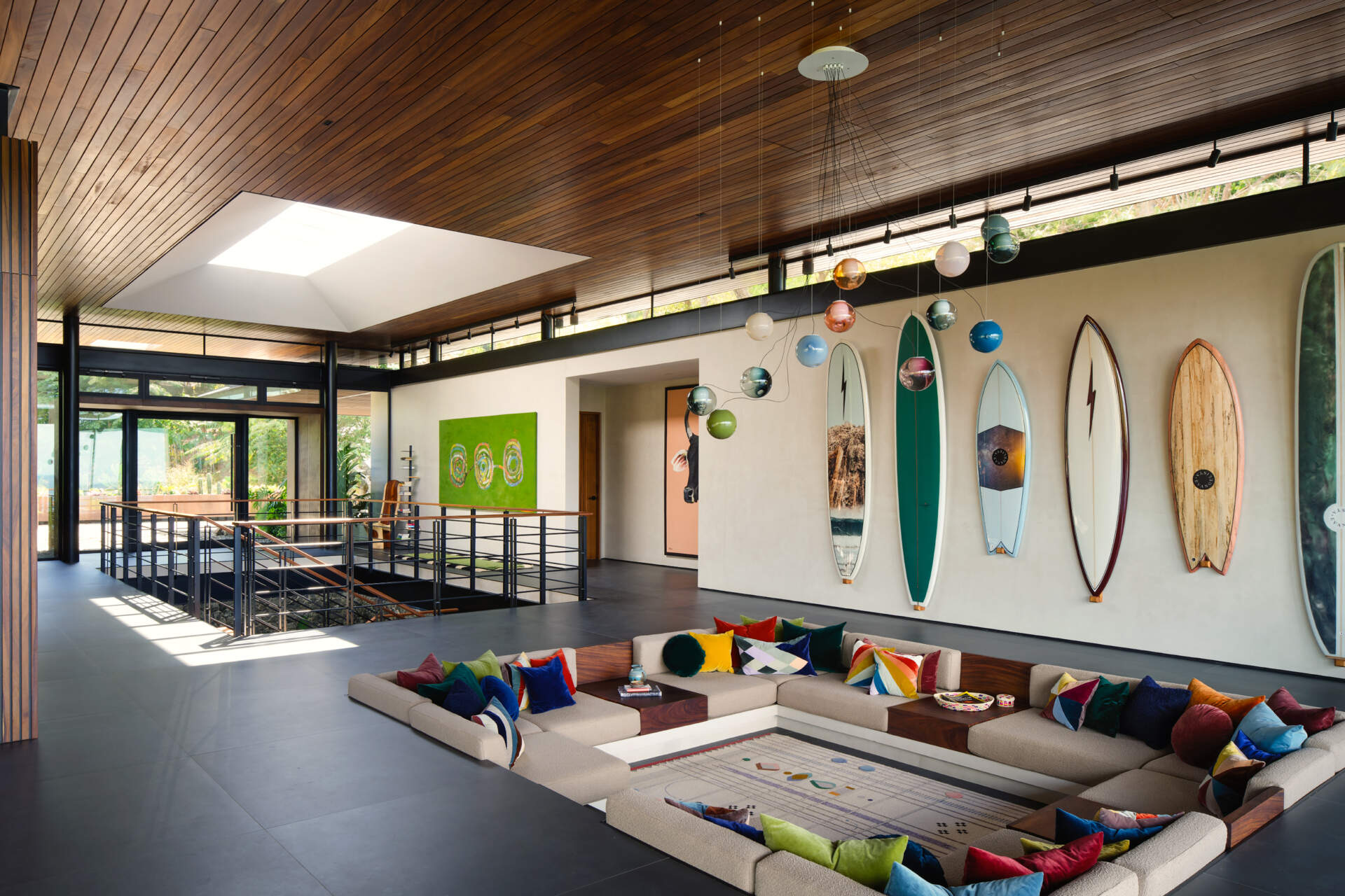 A sunken lounge, colourful accents, and skylights make this one of Casa Akíga's most inviting social spaces.