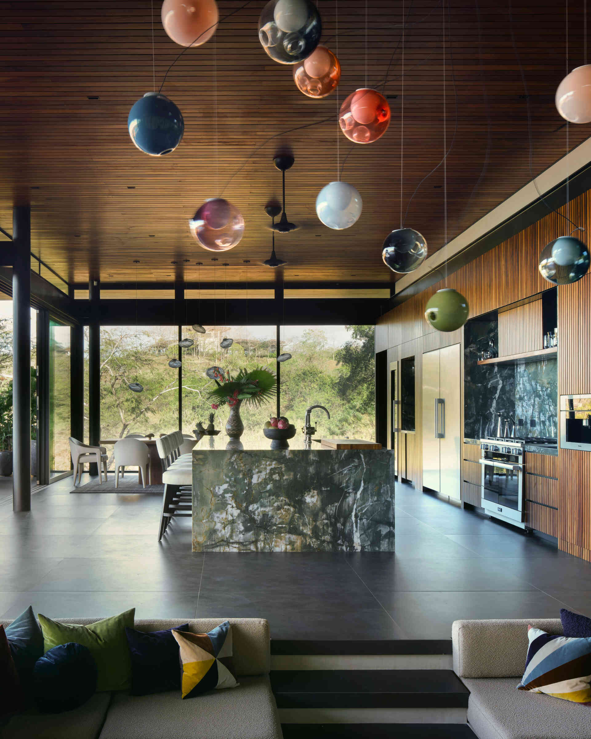 With a dramatic stone island, timber-lined ceilings, and open views, this kitchen is built for cooking and entertaining.