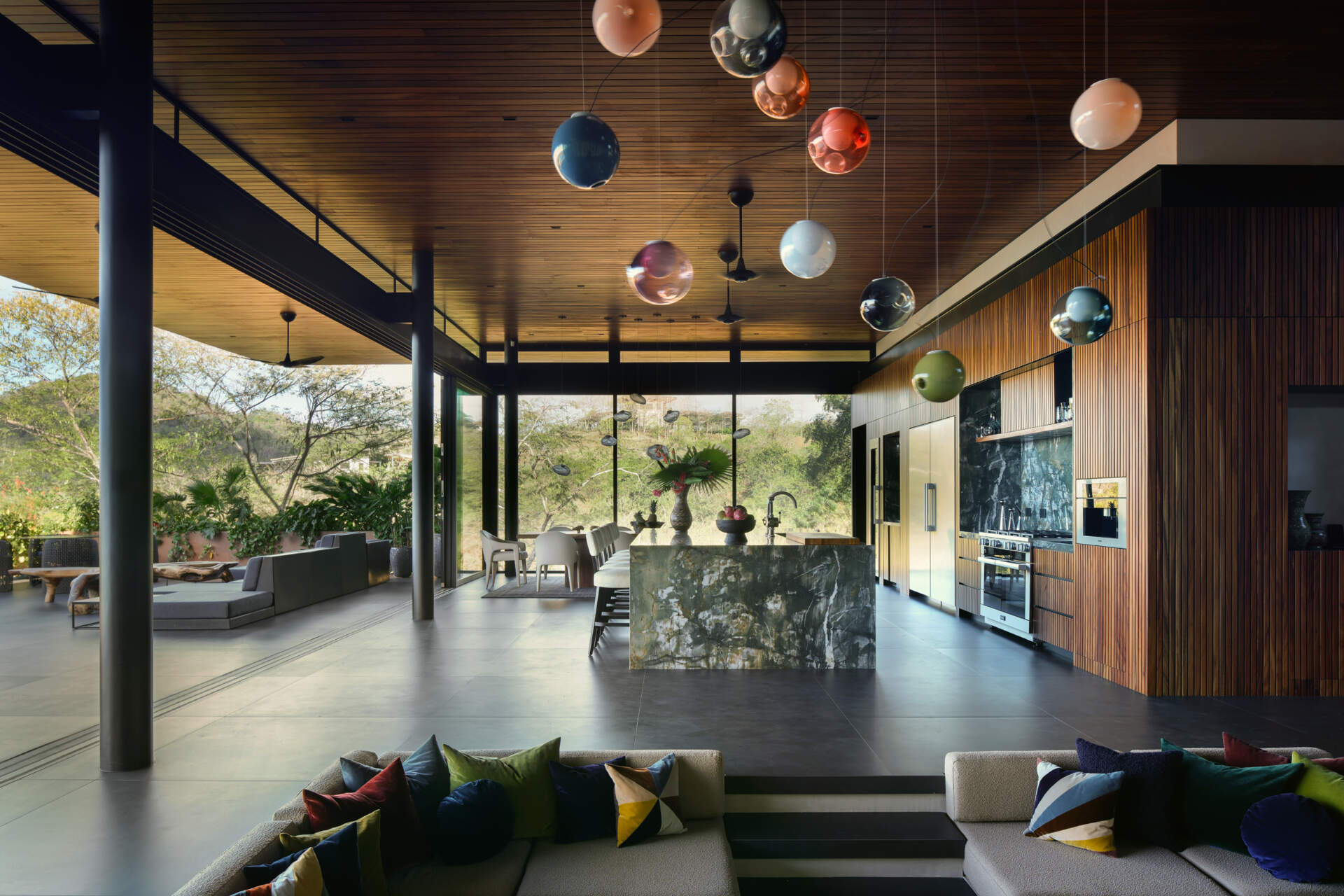 With a dramatic stone island, timber-lined ceilings, and open views, this kitchen is built for cooking and entertaining.