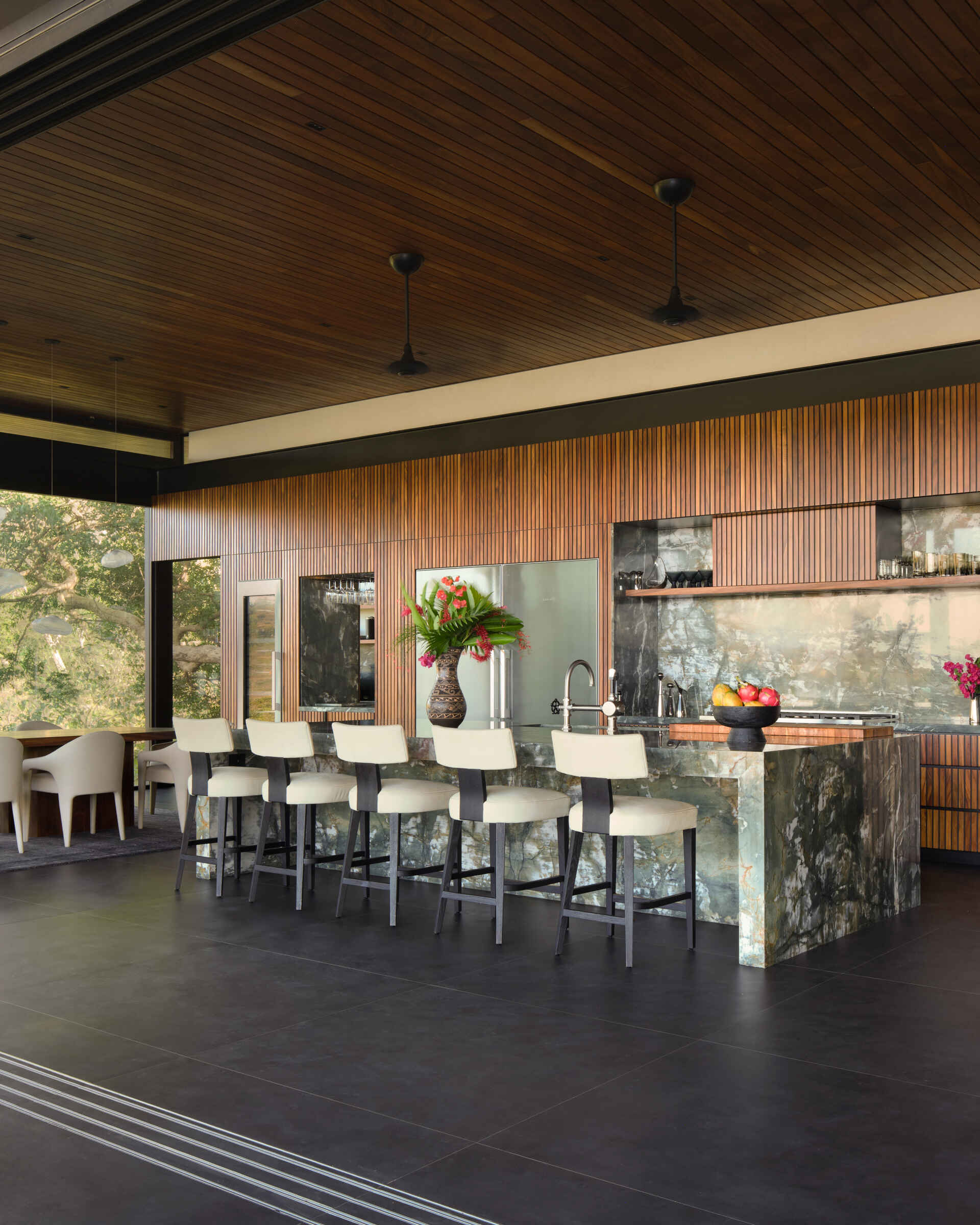 With a dramatic stone island, timber-lined ceilings, and open views, this kitchen is built for cooking and entertaining.