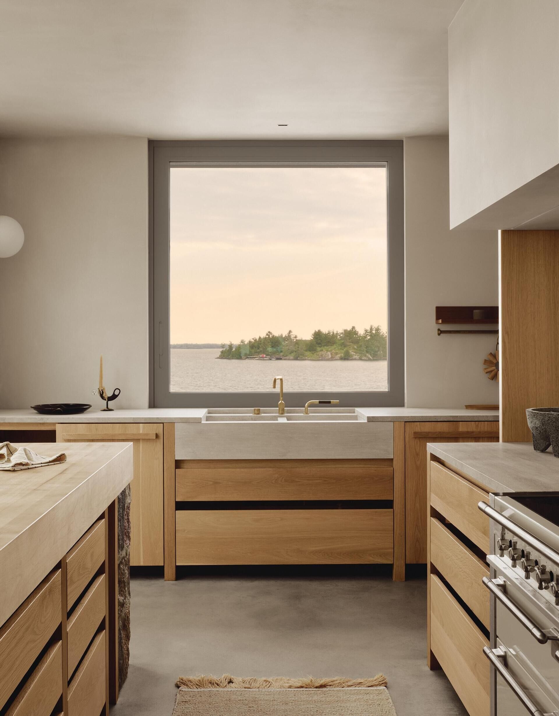 This beautiful kitchen features a fieldstone island, custom oak cabinetry and natural materials inspired by Georgian Bay.