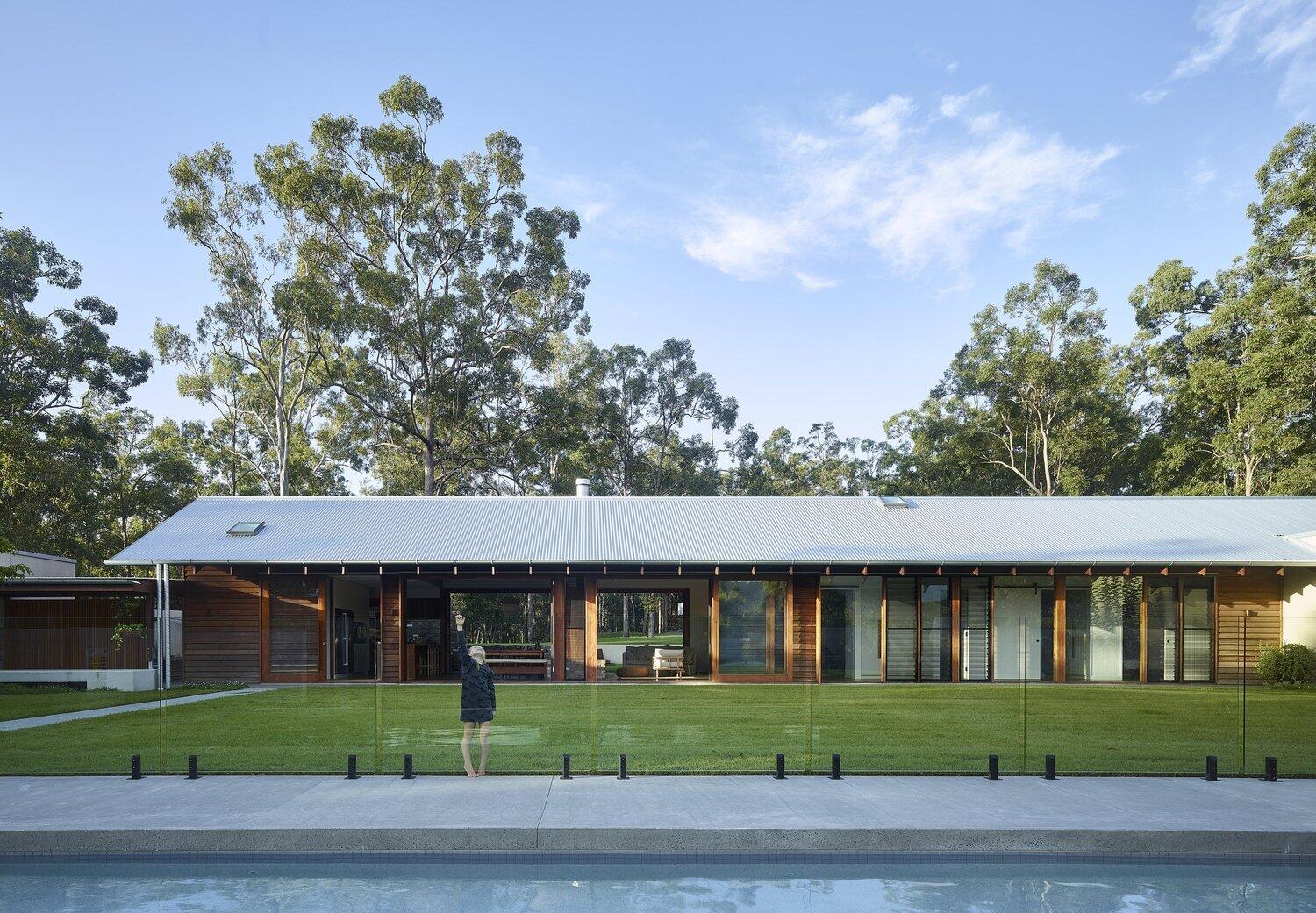 A spacious lawn, outdoor kitchen and swimming pool make this Brisbane acreage home perfect for entertaining.