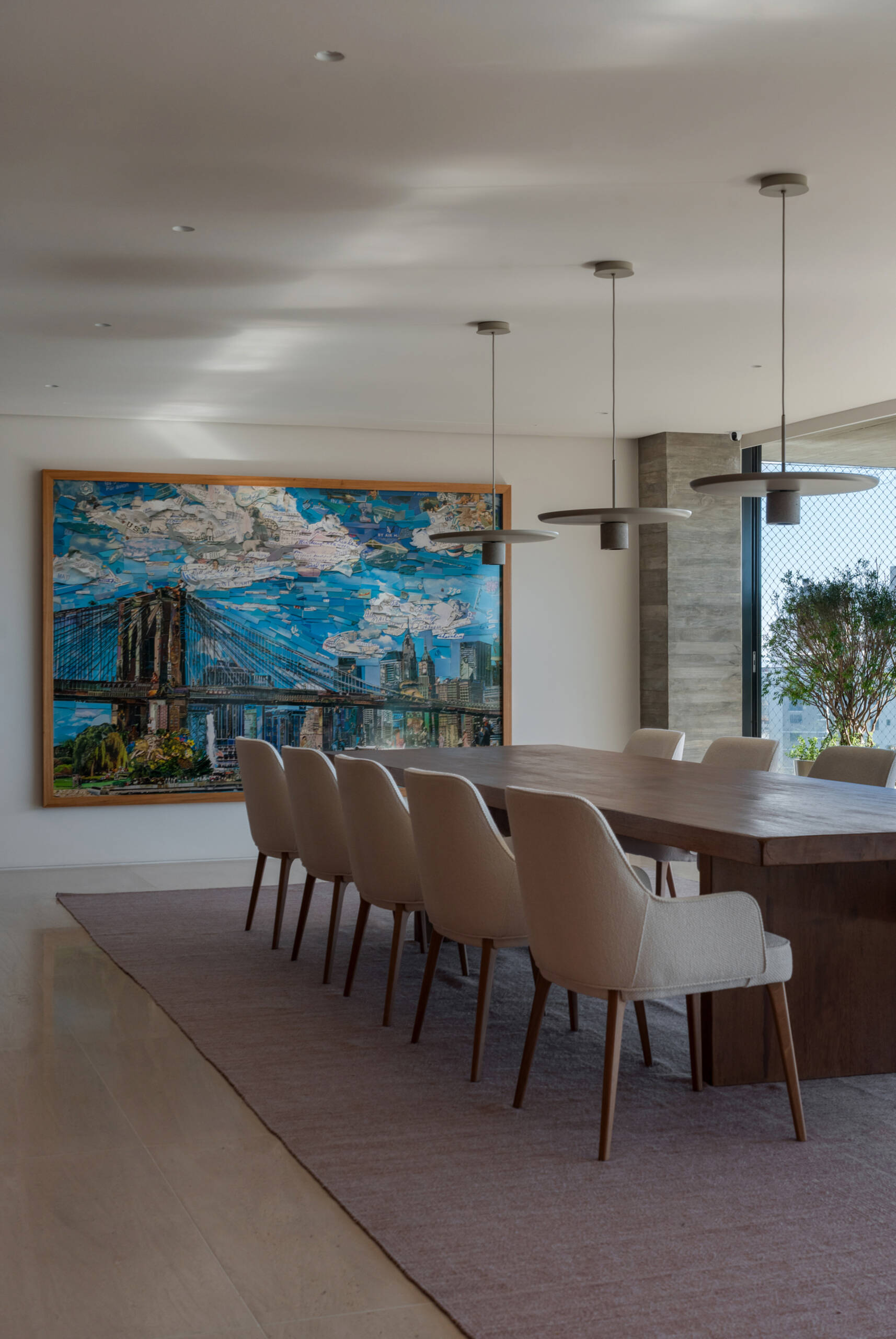 A solid timber dining table, designer lighting and artwork by Vik Muniz make this dining room simple, elegant and welcoming.