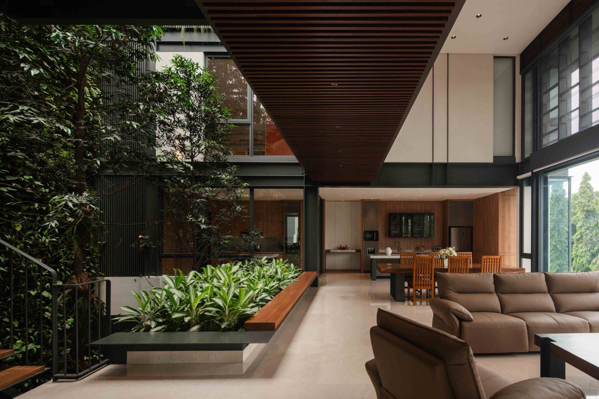 Discover an open-plan living space with park views, exposed steel, warm timber finishes and seamless indoor-outdoor connections.