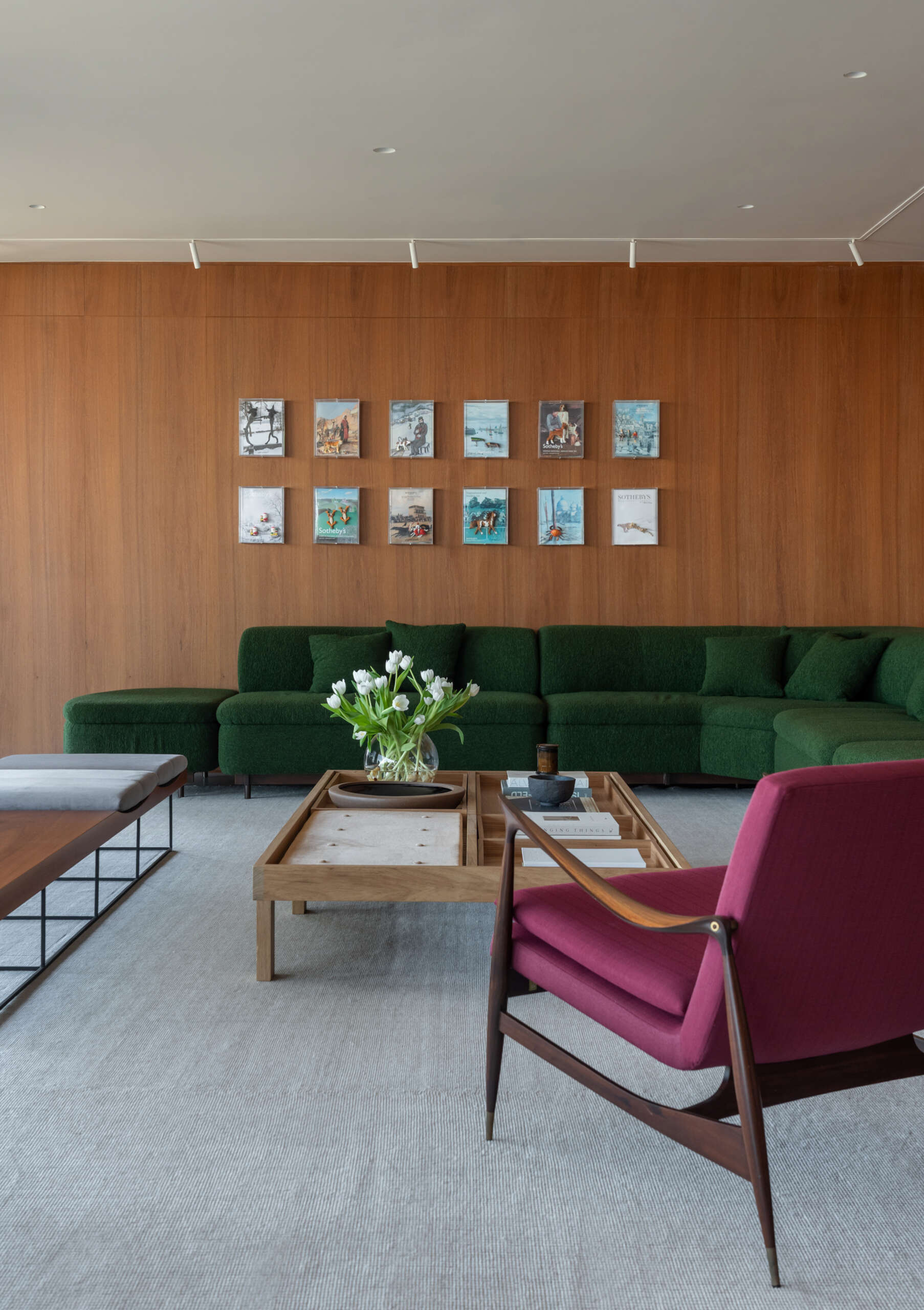 This living room combines iconic Brazilian furniture, limestone floors and expansive city views for a warm, inviting entertaining space.