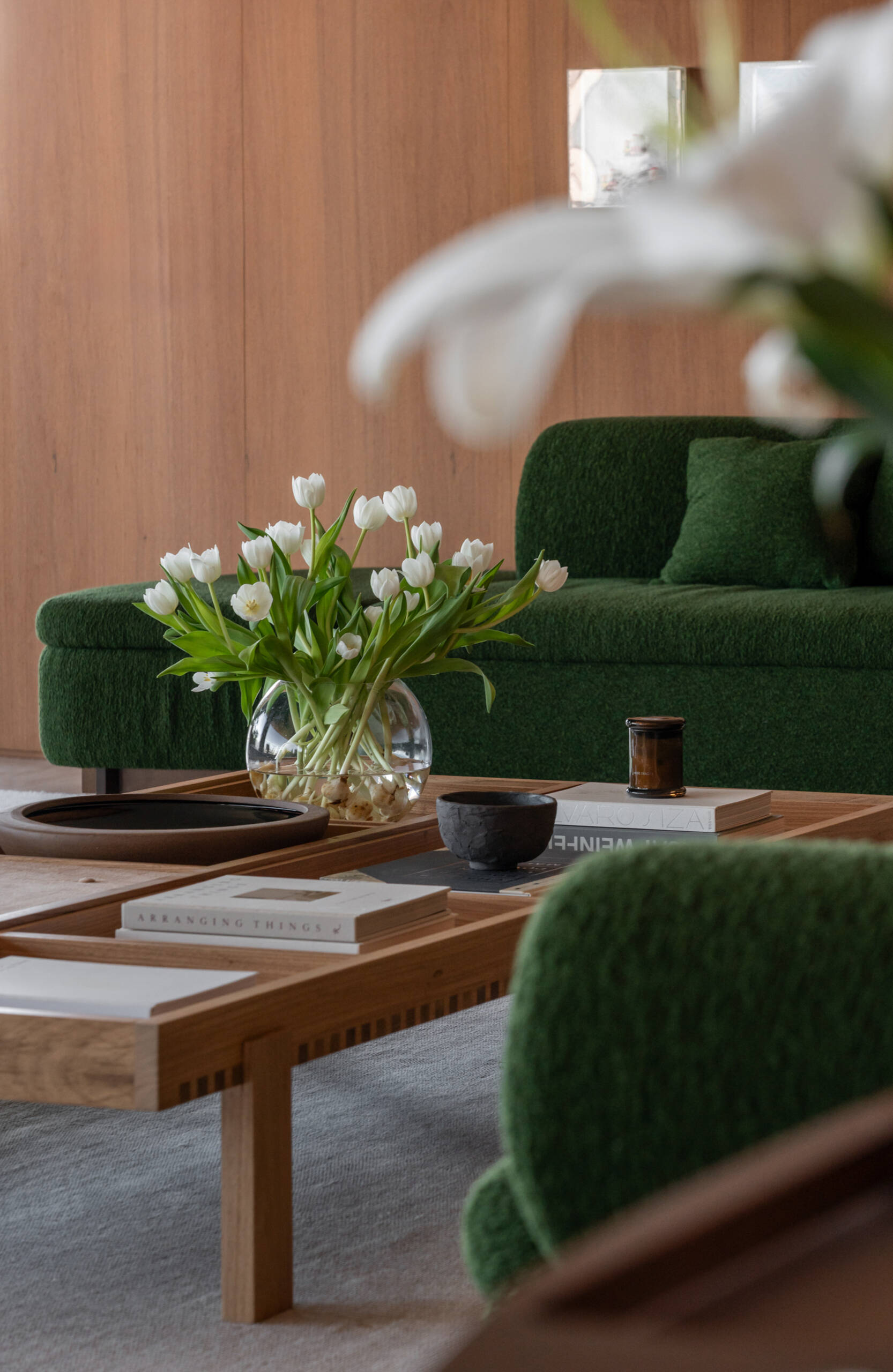This living room combines iconic Brazilian furniture, limestone floors and expansive city views for a warm, inviting entertaining space.