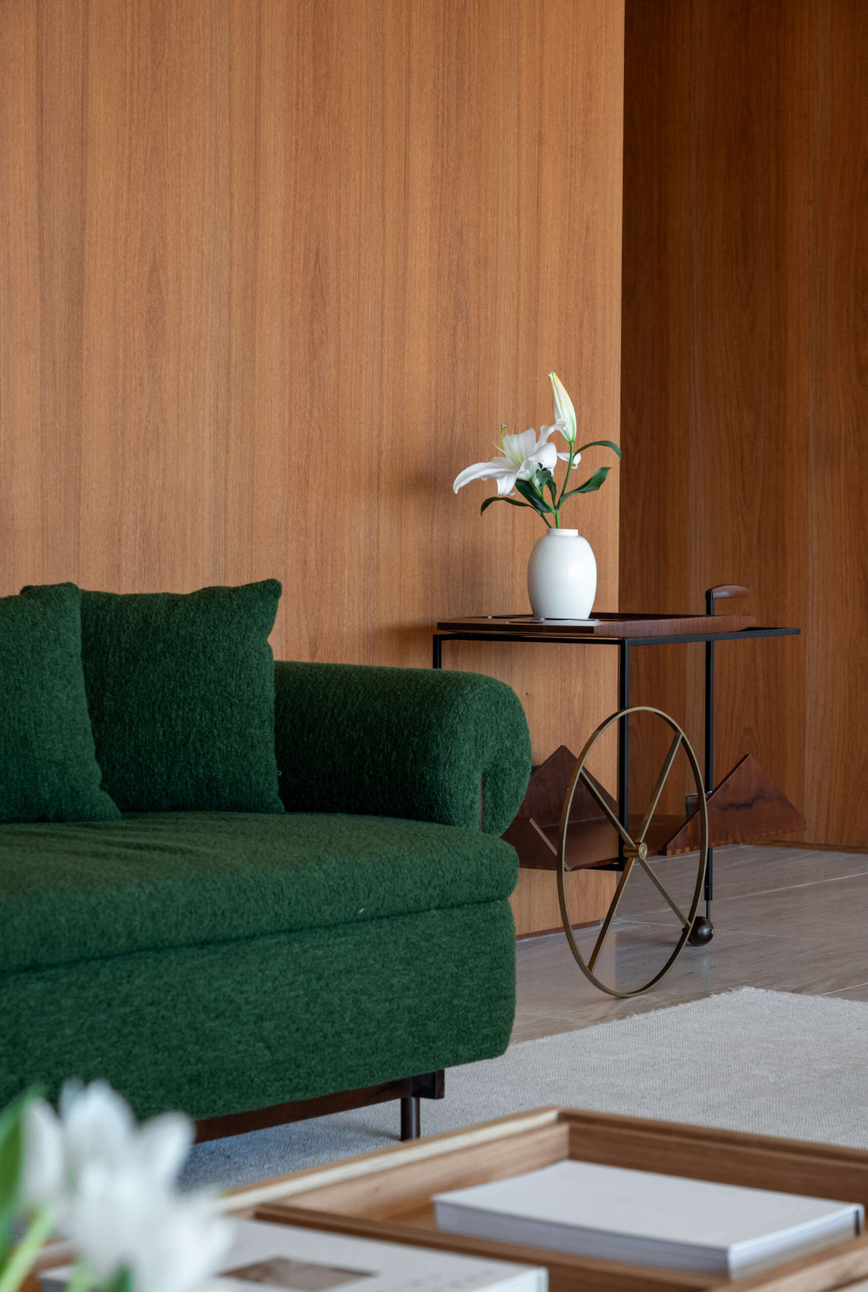 This living room combines iconic Brazilian furniture, limestone floors and expansive city views for a warm, inviting entertaining space.